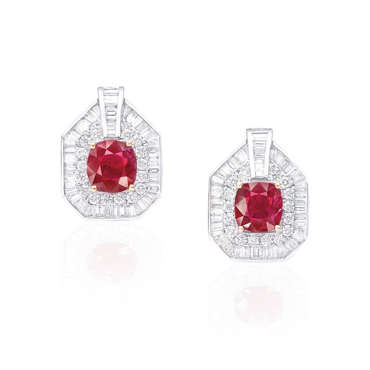 Main stone: 2.01 and 1.92 carats Vivid Red (Pigeon's Blood), Cushion
Setting: 36 round white diamonds totaling approximately 0.64 carats, trapezoid cut white diamonds totaling approximately 4.50 carats

From Emilio Jewelry, a well known and