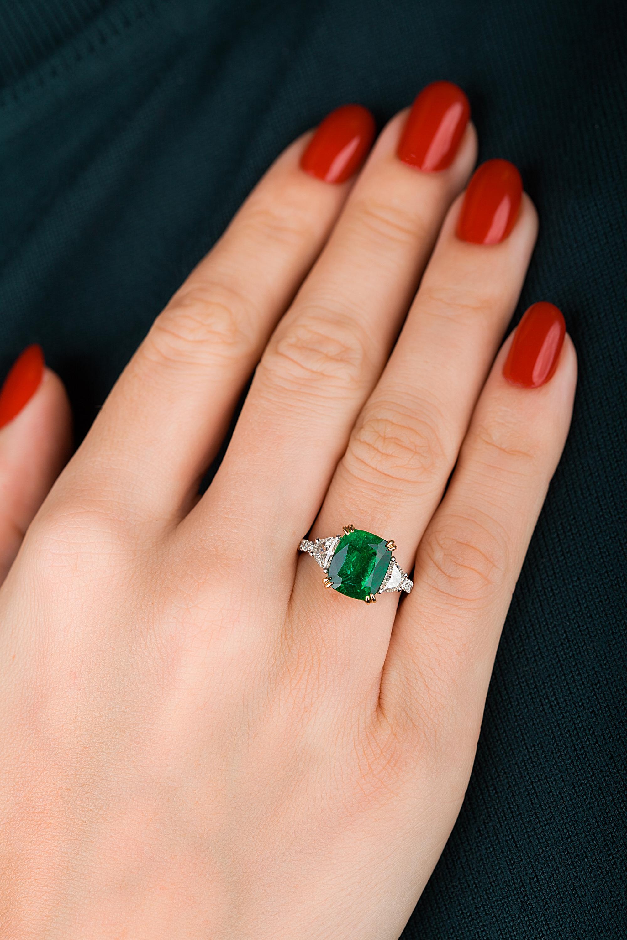 Hand made in the Emilio Jewelry Factory,  Certified Vivid Green Emerald cut Zambian Genuine Emerald 4.22 Carats set in the center. (colombian emeralds are much lighter in color) Based on emerald grading methodology this emerald in our opinion is a