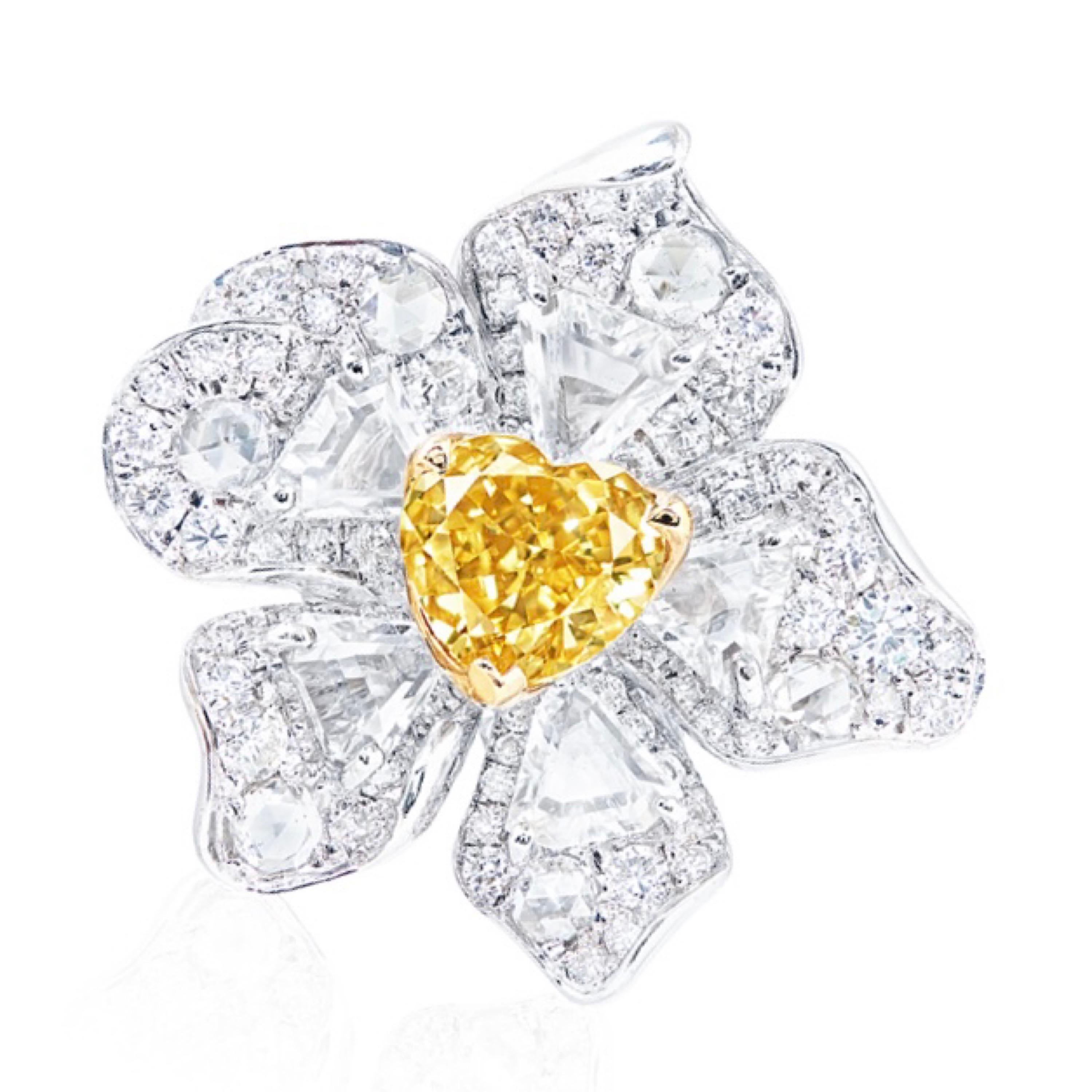 From the museum vault at Emilio Jewelry New York.
Main stone: Gia certified natural 1.00 carats Fancy Intense Yellow heart.
Setting: 72 white diamonds totaling approximately 0.72 carats, 5 white diamonds totaling approximately 1.20 carats, 6