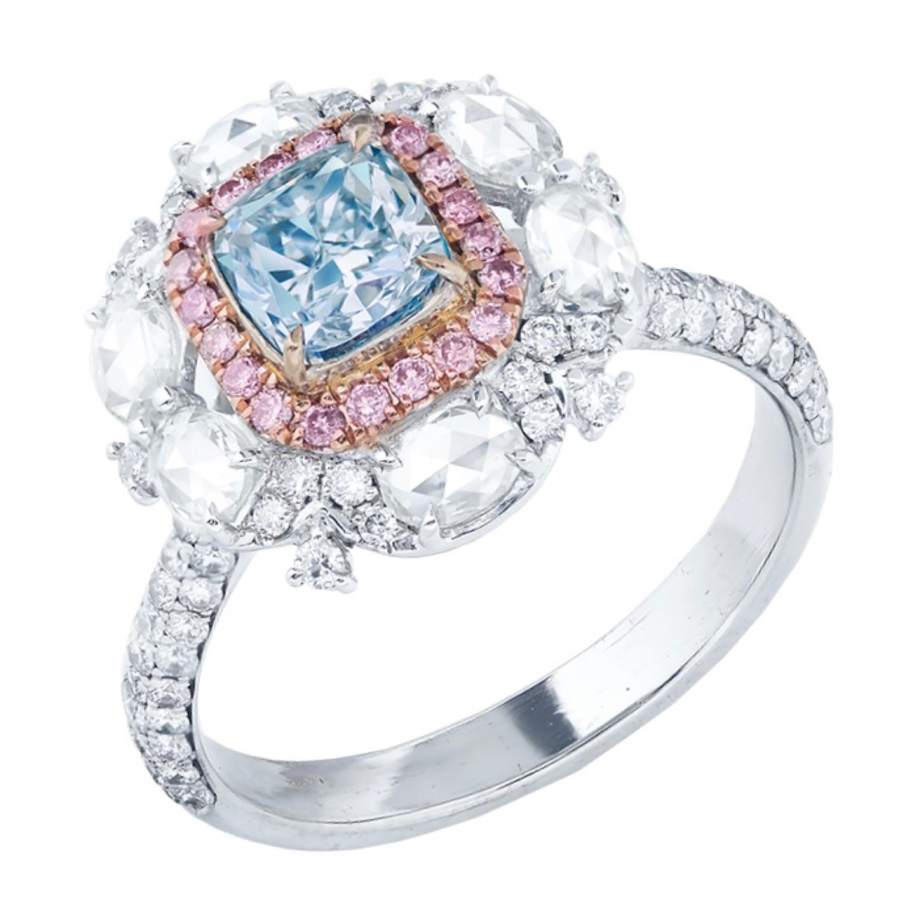Main stone: 1.00 carat
Color: Very Light Blue
Clarity: SI2
Shape: CUSHION
Setting: 116 white diamonds with a total of approximately 0.736 carats, 6 white diamonds with a total of approximately 0.061 carats, 20 pink diamonds with a total of