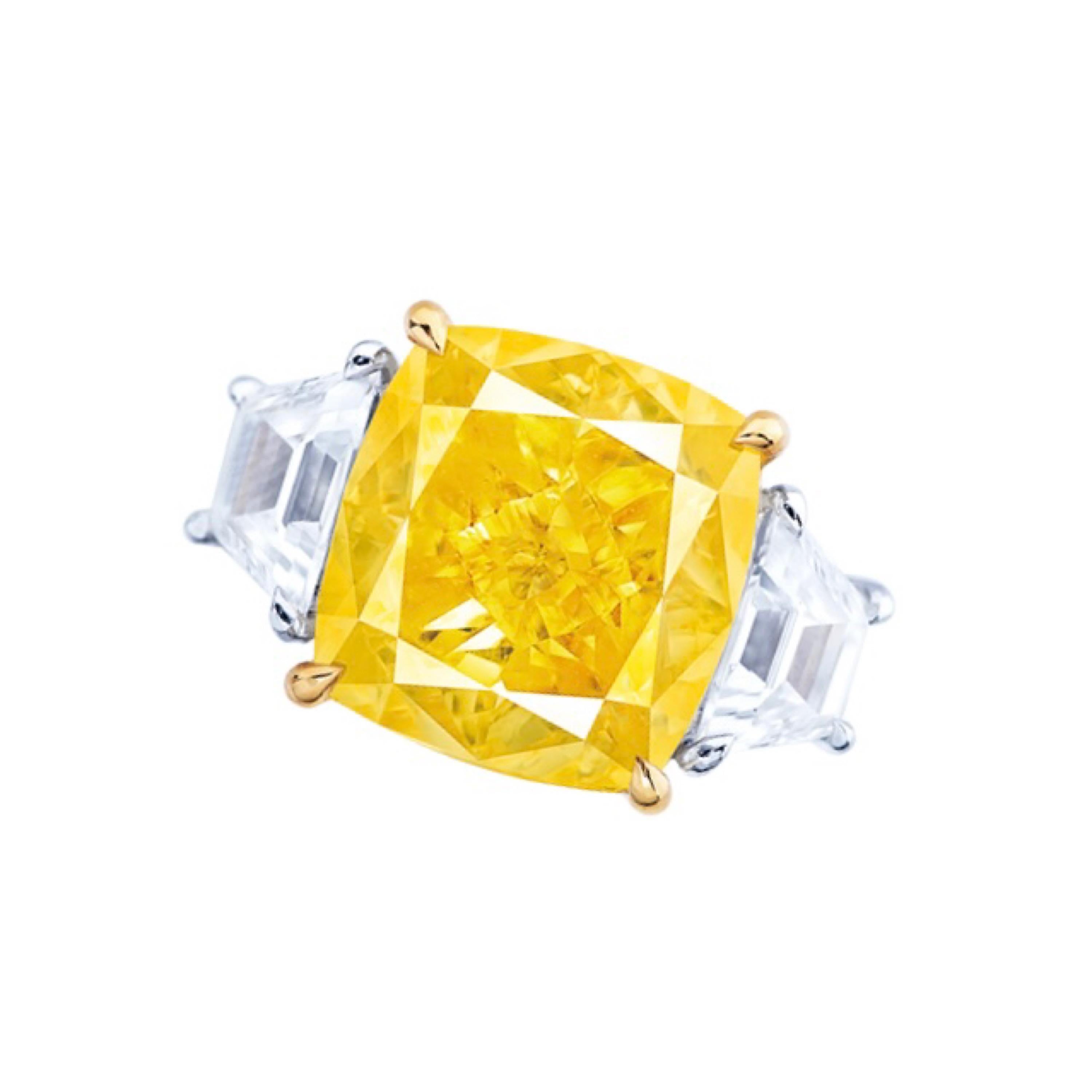 Main stone: 10.02 carats
Color: Fancy Intense Yellow
Clarity: VS2
Shape: CUSHION
Setting: 2 white diamonds totaling approximately 1.36 carats
Material: 18K
From the Emilio Jewelry Vault,  This diamond is one of a kind, because it has no overtone and
