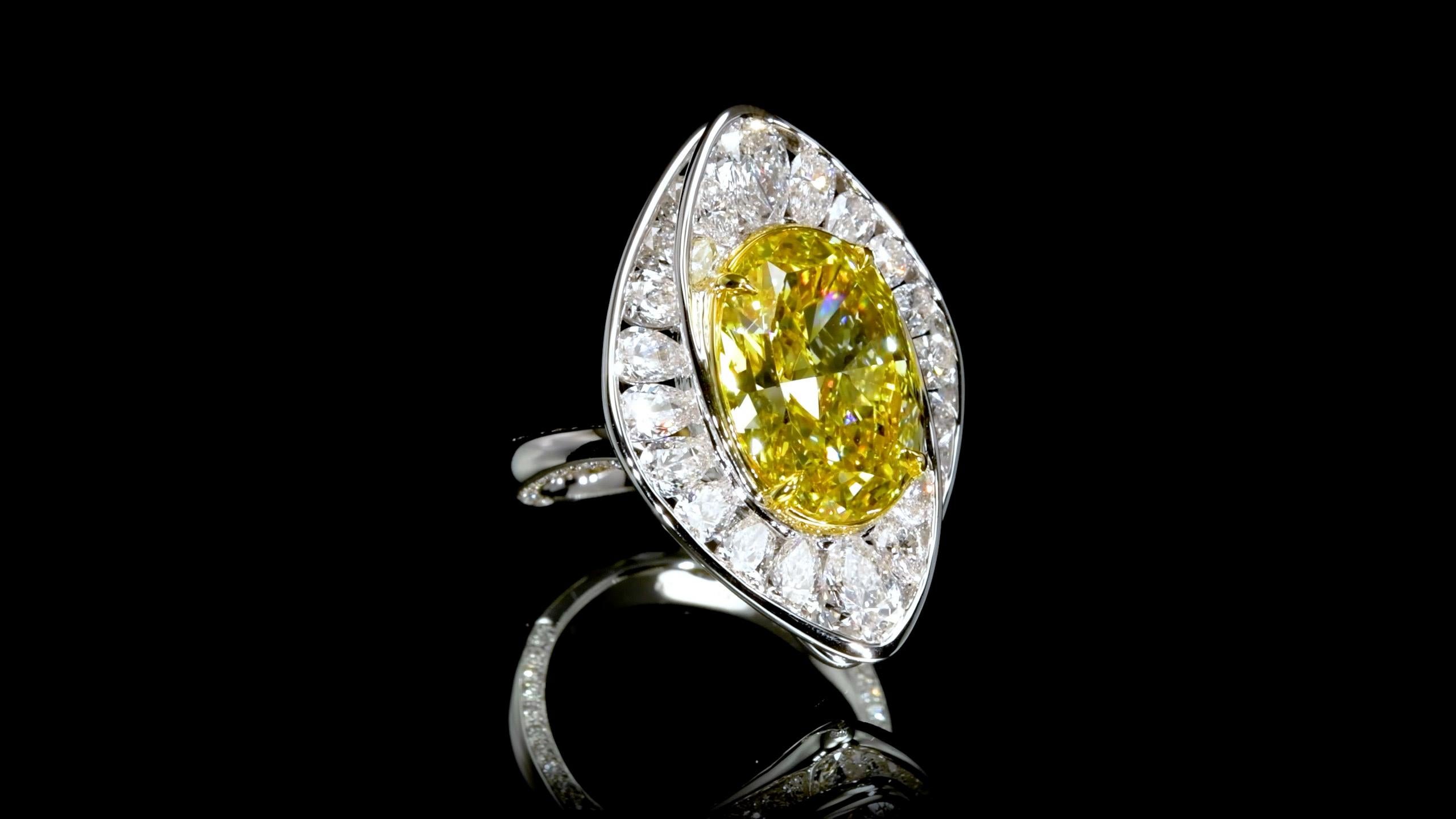 From Emilio Jewelry, a well known and respected wholesaler/dealer located on New York’s iconic Fifth Avenue, 
In the center: A Majestic most rich vibrant Gia Certified Natural Fancy Deep Yellow diamond stuns from miles away. Set with an array of D-F