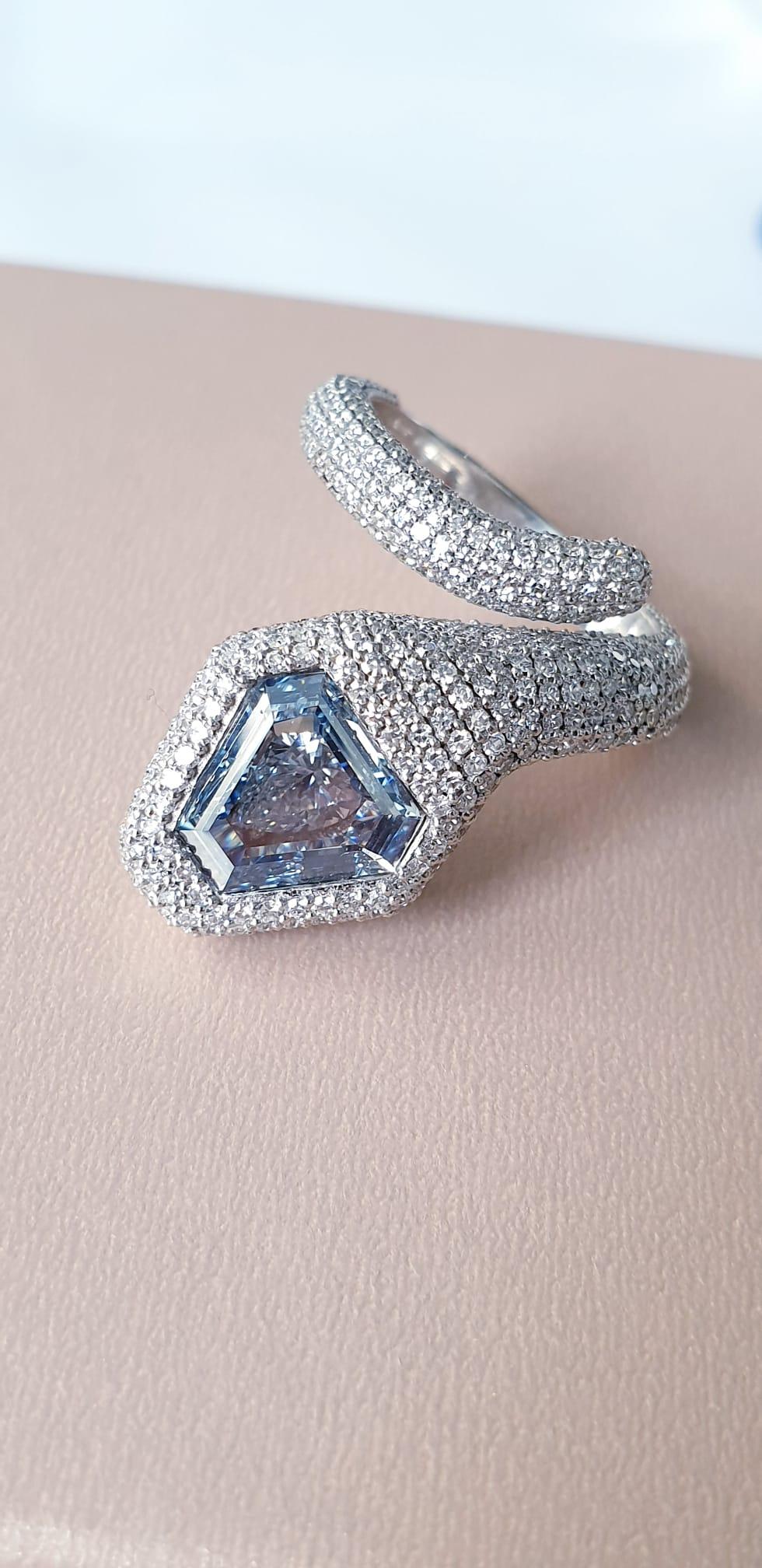 From The Museum Vault At Emilio Jewelry New York,

Main stone: Gia certified natural Fancy intense pure blue diamond Shield cut with no overtone set in the center just over 1.25 carats. Uniquely enough we set a large white pear shape just under the