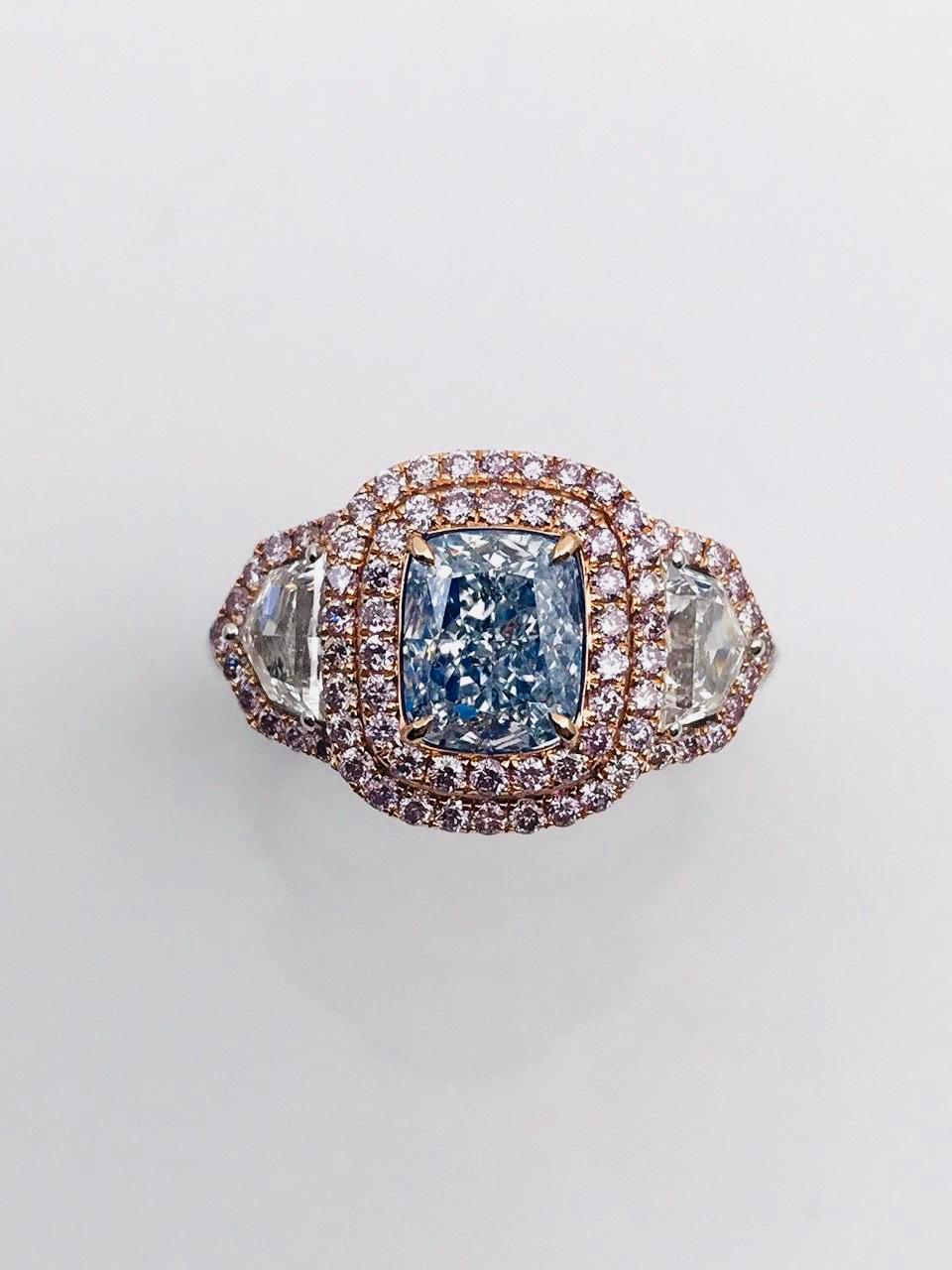 From the Emilio Jewelry Vault, Showcasing a magnificent investment grade 1.30 carat Gia certified natural fancy very light pure blue center stone with no overtone or secondary colors.  With Emilio's expertise after setting the center faces up with a