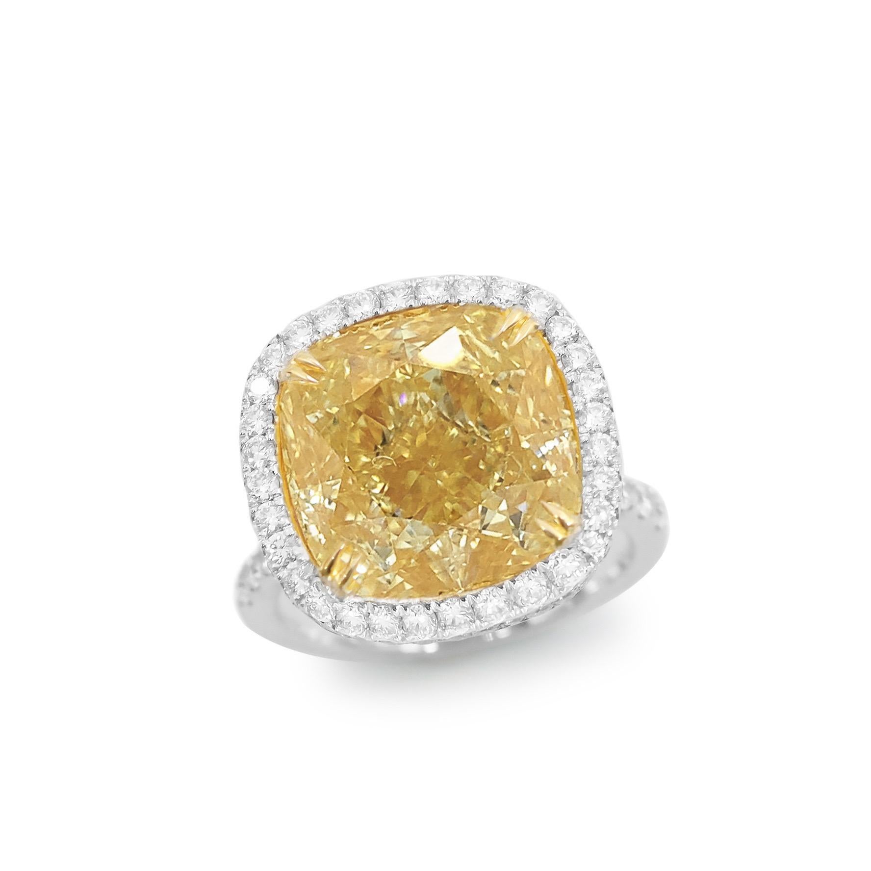 From Emilio Jewelry, a well known and respected wholesaler/dealer located on New York’s iconic Fifth Avenue, 

The focal point of this ring is the magnificent Gia Certified Natural Fancy Yellow Diamond in the center weighing alone over 12ct. After