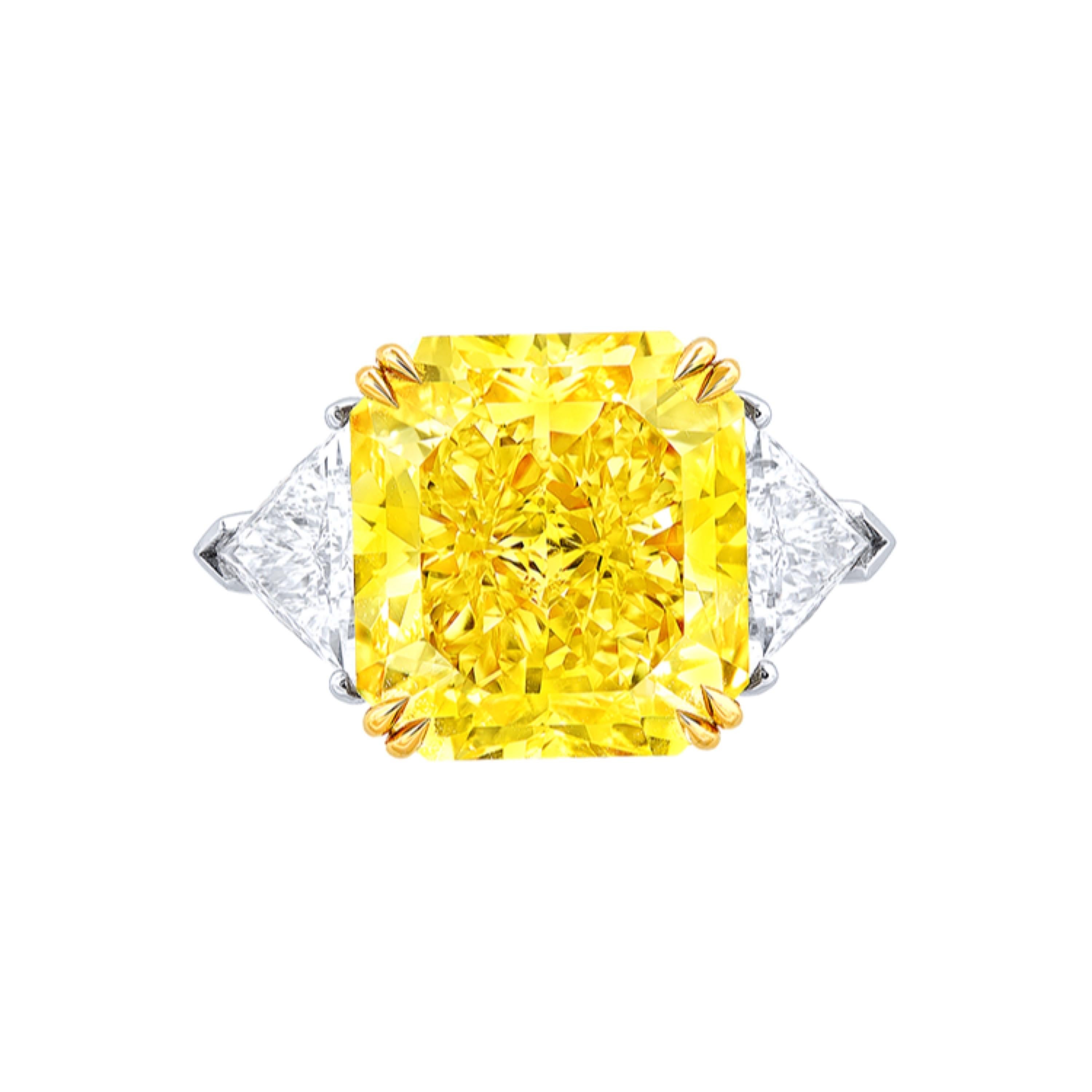 From the museum vault at Emilio Jewelry located on New York's iconic 5th Avenue,

Center Stone: 14.00ct+ Fancy Intense Yellow VS1 CUT-CORNERED RECTANGULAR
Matching setting: side white diamond about 1.14 carats, 
