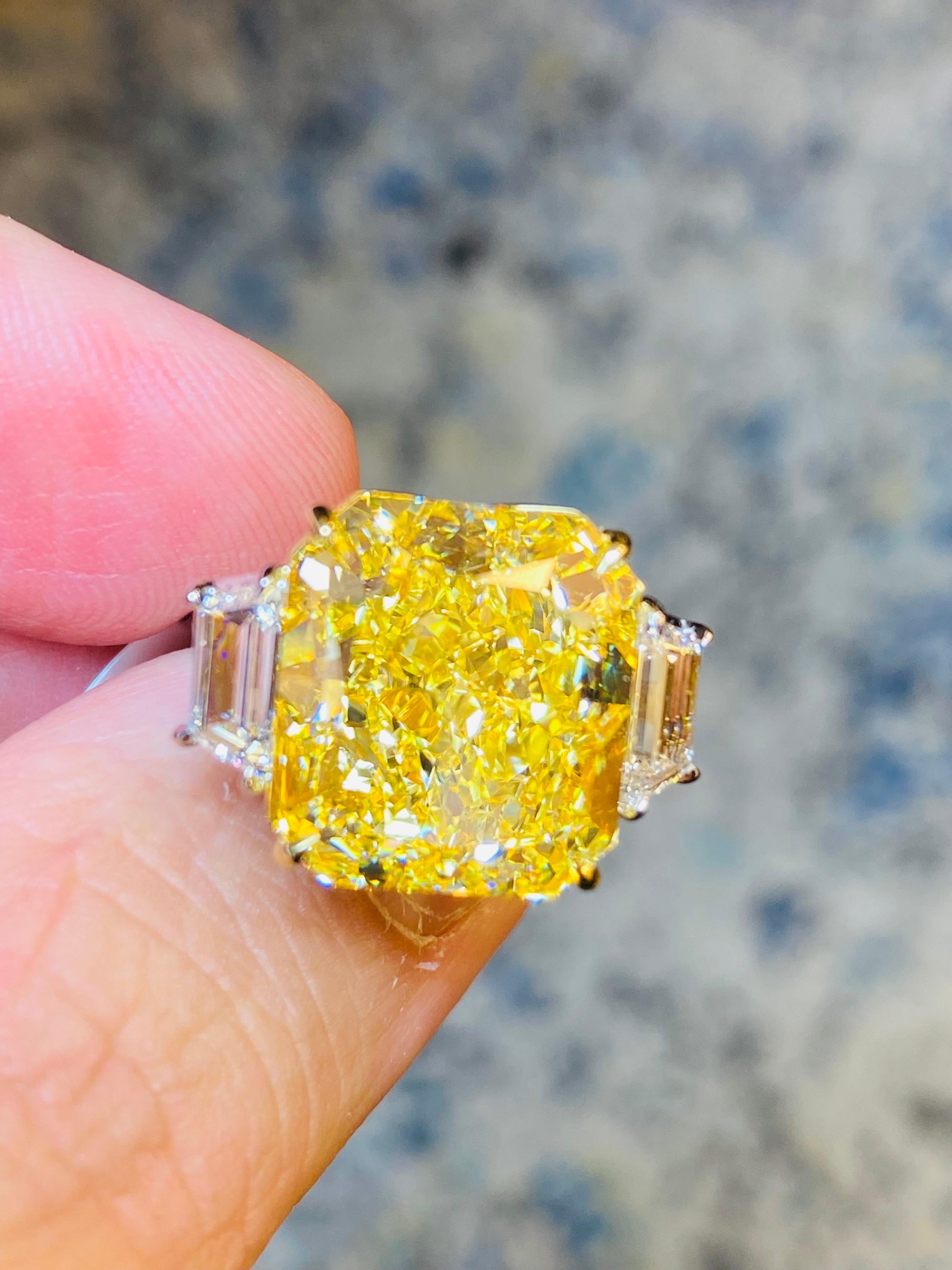 From Emilio Jewelry, a well known and respected wholesaler/dealer located on New York’s iconic Fifth Avenue,
The focal point of this ring is featuring a Gia certified natural Fancy Intense yellow diamond with a true golden appearance set in the