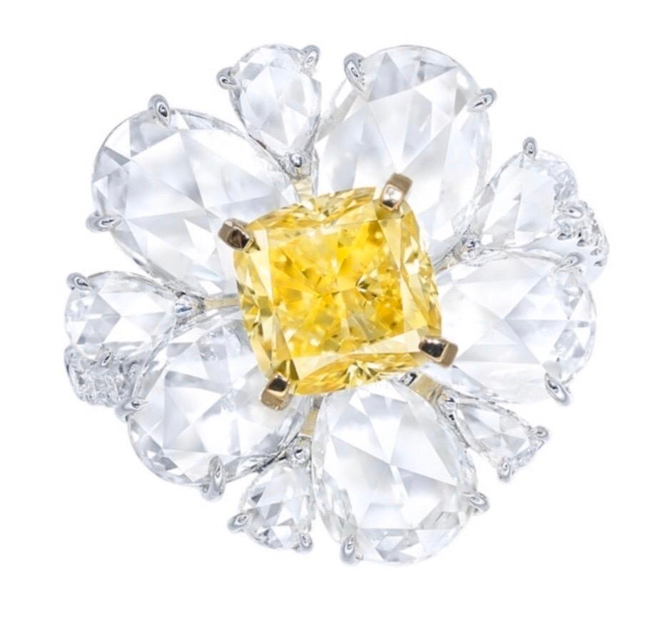 Showcasing a certified Gia certified natural fancy vivid yellow diamond weighing approx. 1.85 carats in the center. Side Diamonds total approx. 4.10cts. 
This piece was Hand made in the Emilio Jewelry Atelier, whom specializes in rare collectible