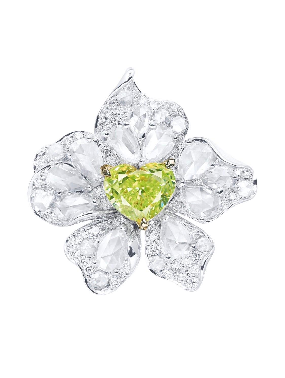From the Emilio Jewelry Museum Vault, Showcasing a stunning certified 2.00 carat Gia certified natural fancy intense yellow green heart shape center. There are an additional 3.90 carats of white diamonds set in this custom created ring. 
We are