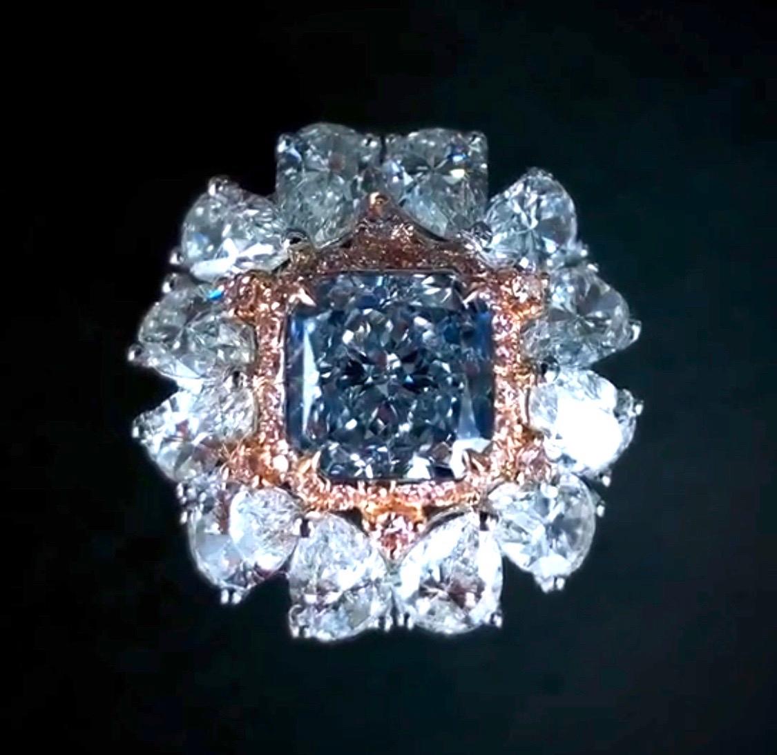 From the Emilio Jewelry Vault, Showcasing a stunning Gia certified 2.00 fancy light gray blue diamond in the center. The mounting was custom made around the center stone. After setting with a very special rhodium technique, the center faces up as a