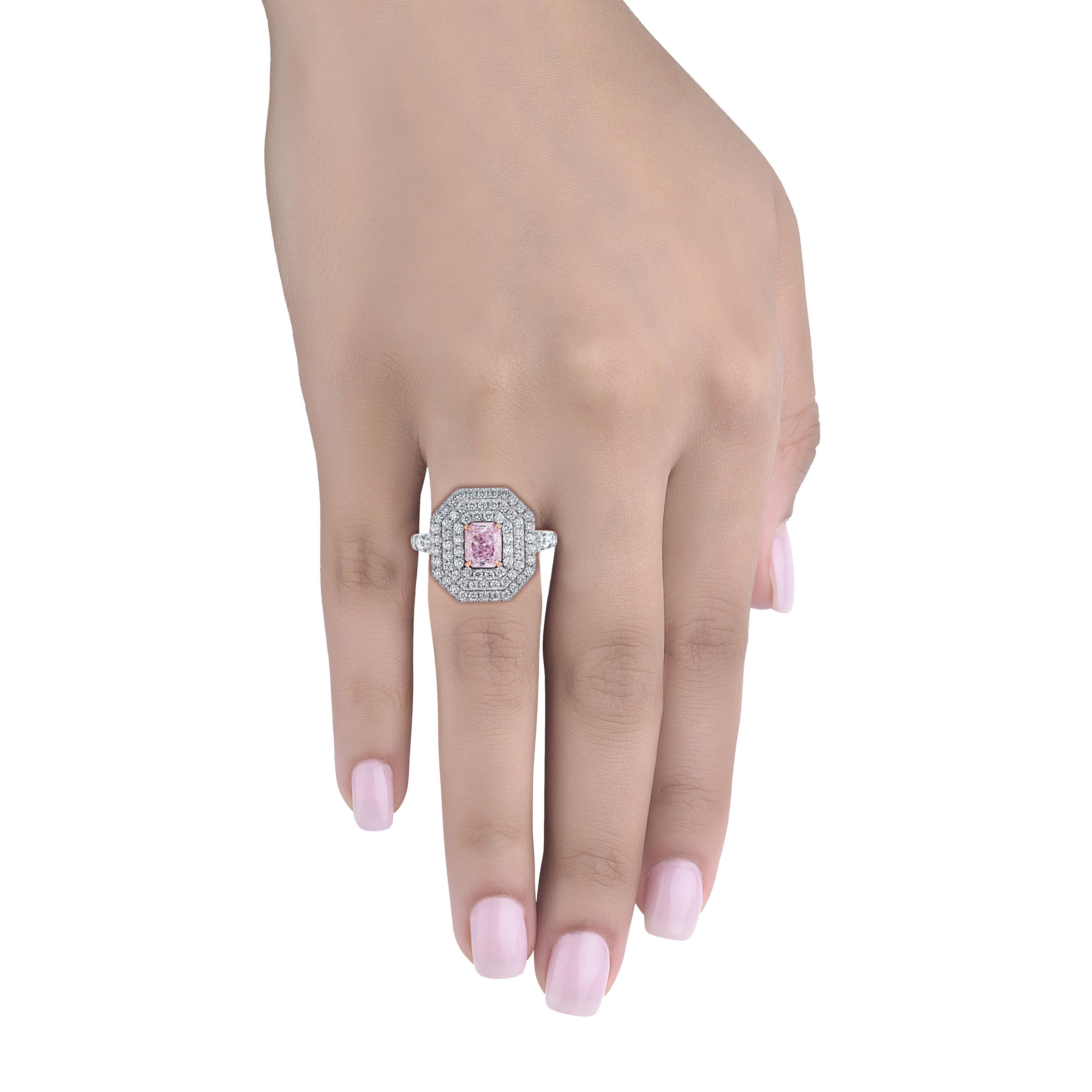 Hand made in the Emilio Jewelry Factory, this ring is a work of art! The center Pink diamond is GIA certified as a 1.01ct Fancy very light pink diamond/I1 clarity and is completely eye clean. The center is full of life and we made this ring to bring