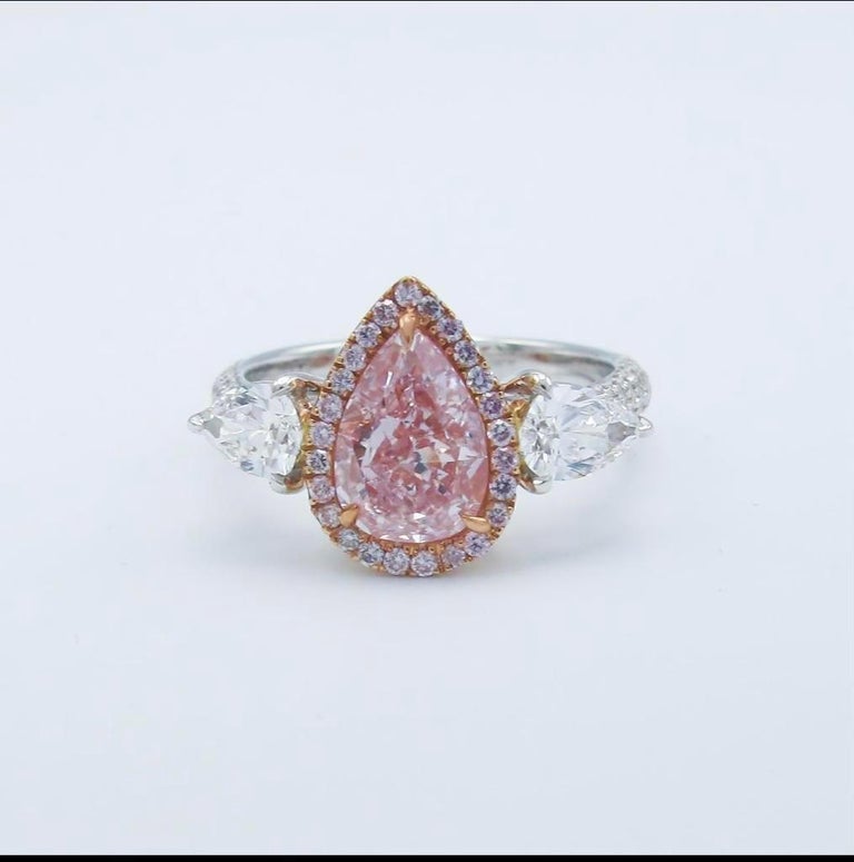 From The Museum Vault At Emilio Jewelry New York,
A magnificent Gia Certified 1.50ct Fancy purplish pink diamond sits in the center of this beauty. The color is sweet and also known in the market as bubble gum and desirable. Approximate total weight