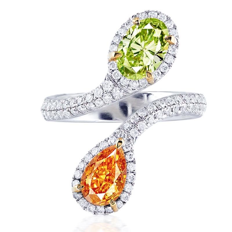 Main stone: 1.00 carat natural Fancy Intense Yellow-Orange, 1.00 carat Fancy Green-Yellow  
Setting: 86 white diamonds with a total of approximately 0.654 carats, 18K    
The design of the double main stone represents the two people closely