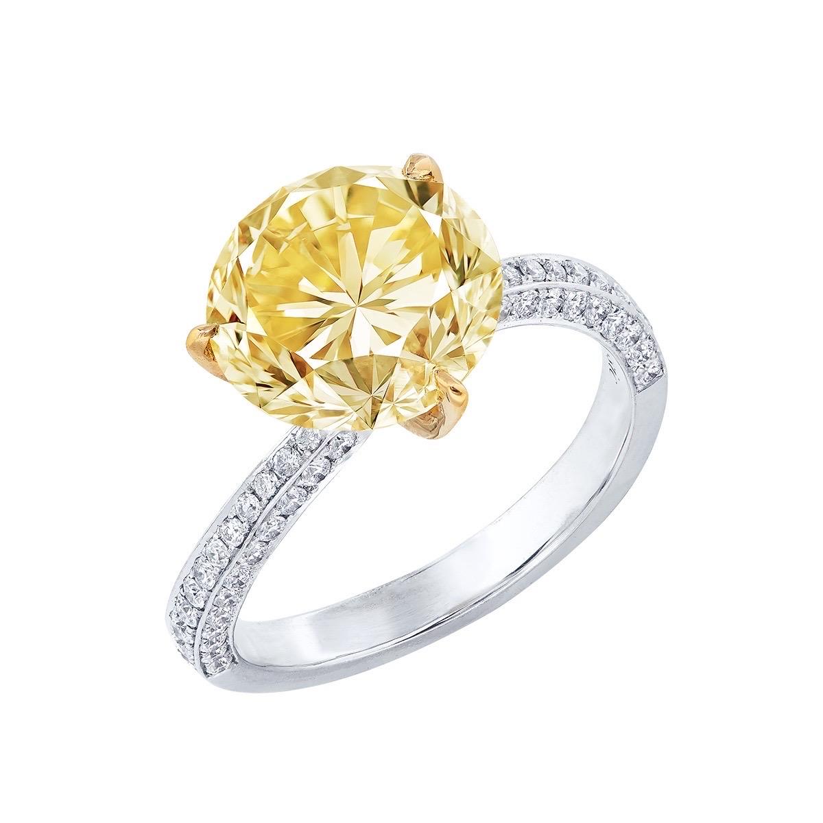 From the vault at Emilio Jewelry located on New York's iconic Fifth Avenue. 
Center Stone: Over 4.00ct Fancy Intense Yellow VVS1 ROUND
Matching: 99 white diamonds totaling about 0.45 carats, 18K
Natural colored diamonds are extremely rare, with one