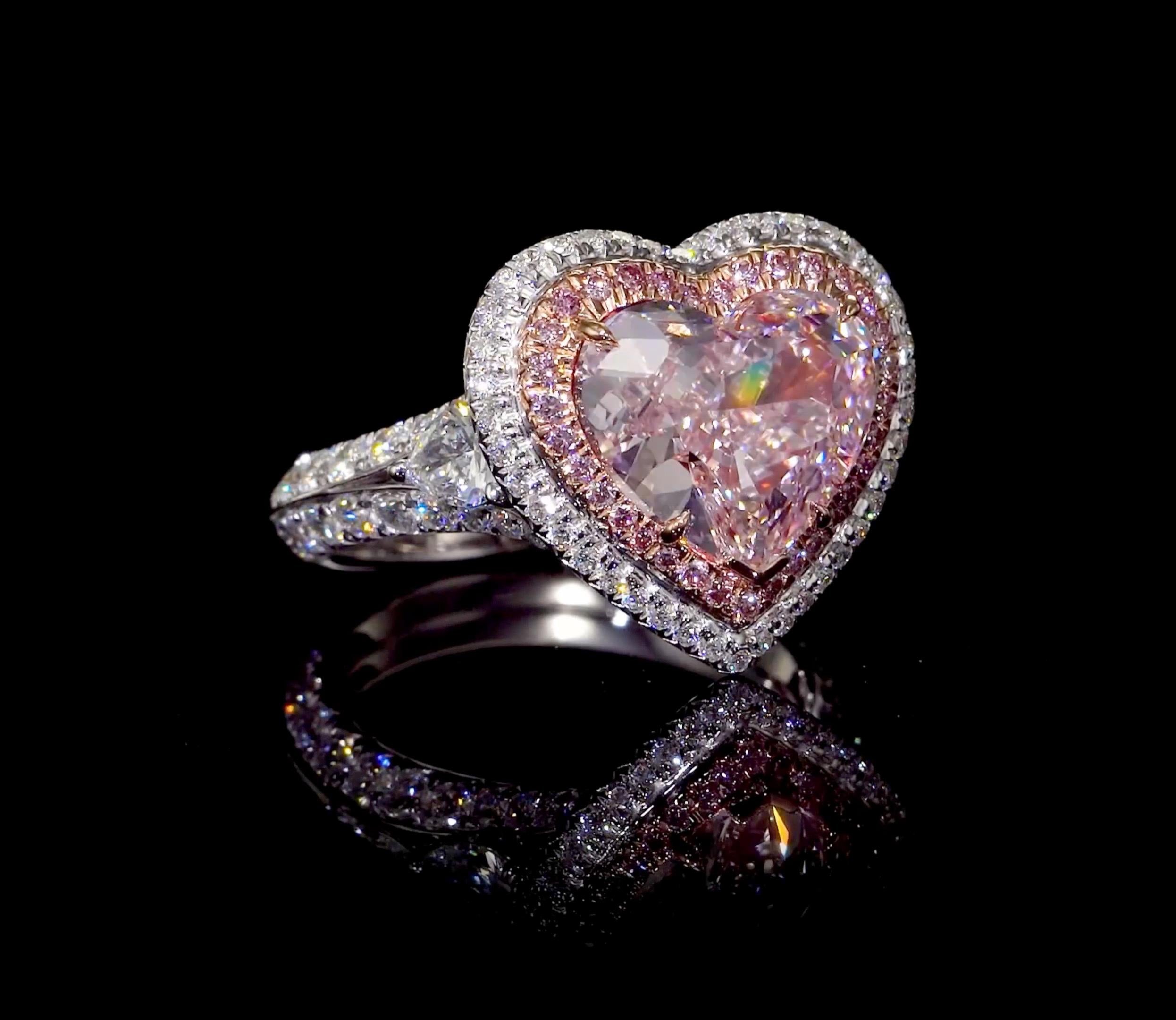 From The Museum Vault At Emilio Jewelry New York,
Featuring a center natural Gia certified fancy light pink diamond internally flawless heart shape center. Filled with tremendous fire, sparkle and dance the center diamond is a dream for whoever will