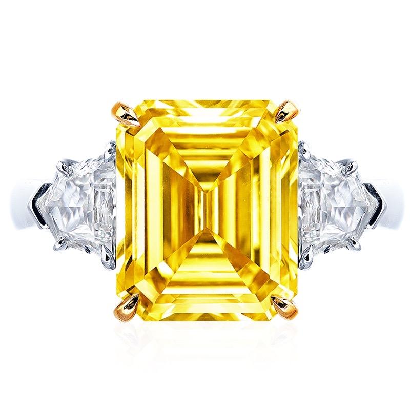 From the Museum Vault at Emilio Jewelry New York,
Main stone: 5.00 carats Fancy Vivid Yellow EMERALD CUT
Matching setting: 2 fancy-cut white diamonds totaling approximately 0.78 carats, 18K
Certificate: GIA 
The charming hue of yellow diamonds has