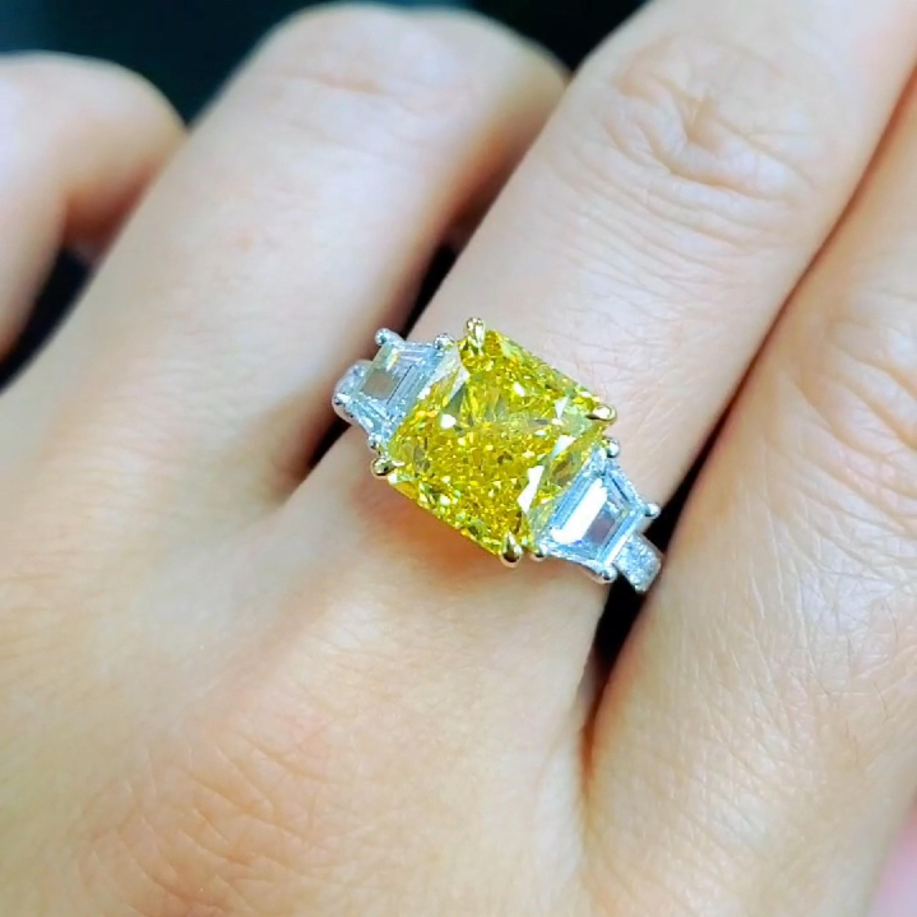 From Emilio Jewelry, a well known and respected wholesaler/dealer located on New York’s iconic Fifth Avenue, 
Featuring a center diamond of the highest color saturation, Fancy Vivid Yellow weighing just over 5.00 carats. 
The color is just