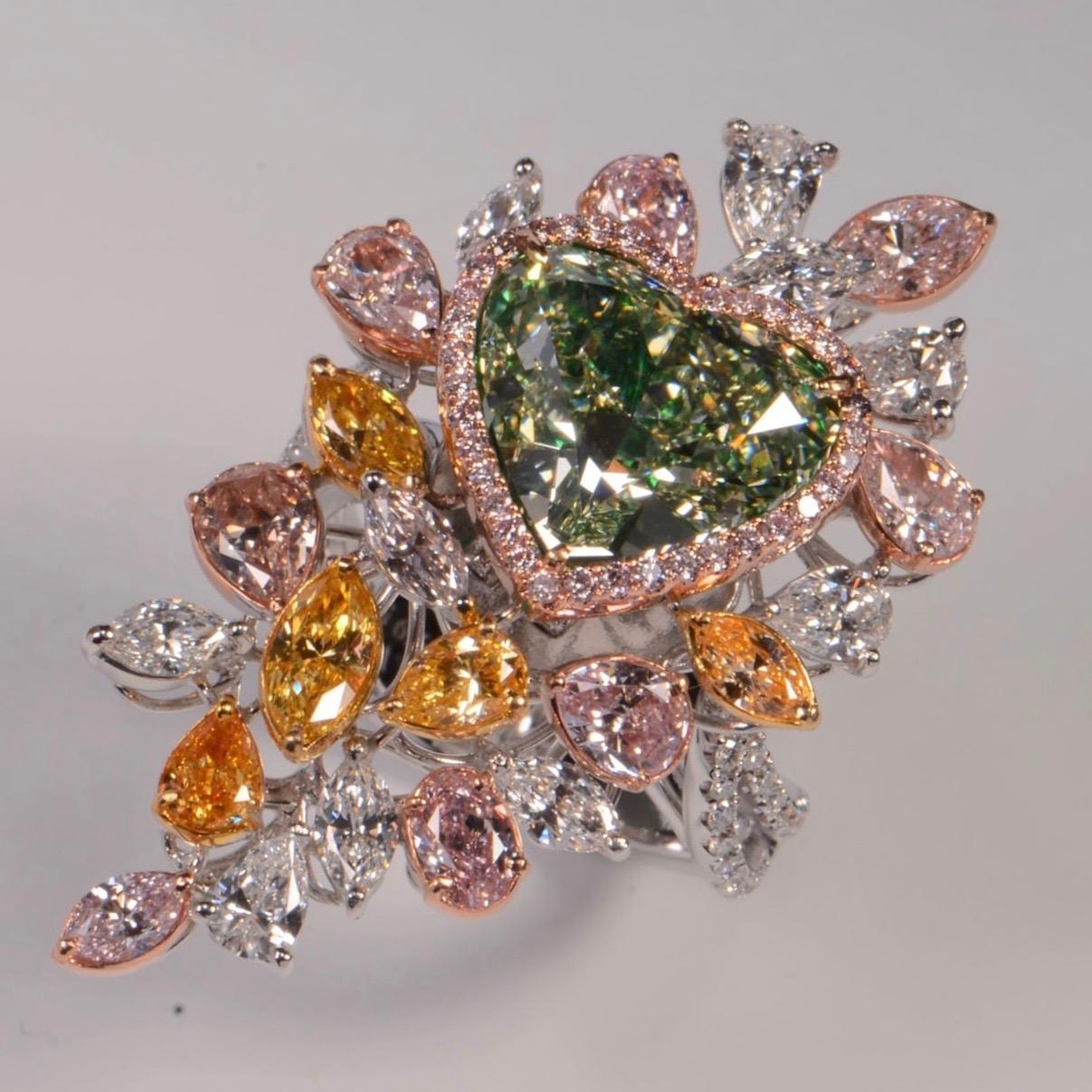 From the Emilio Jewelry Museum Vault, We are proudly Showcasing a Gia certified Natural Fancy yellow green heart shaped diamond in the center. The diamond is exceptional and clean. We can easily redesign this to a simple everyday ring. 
This piece