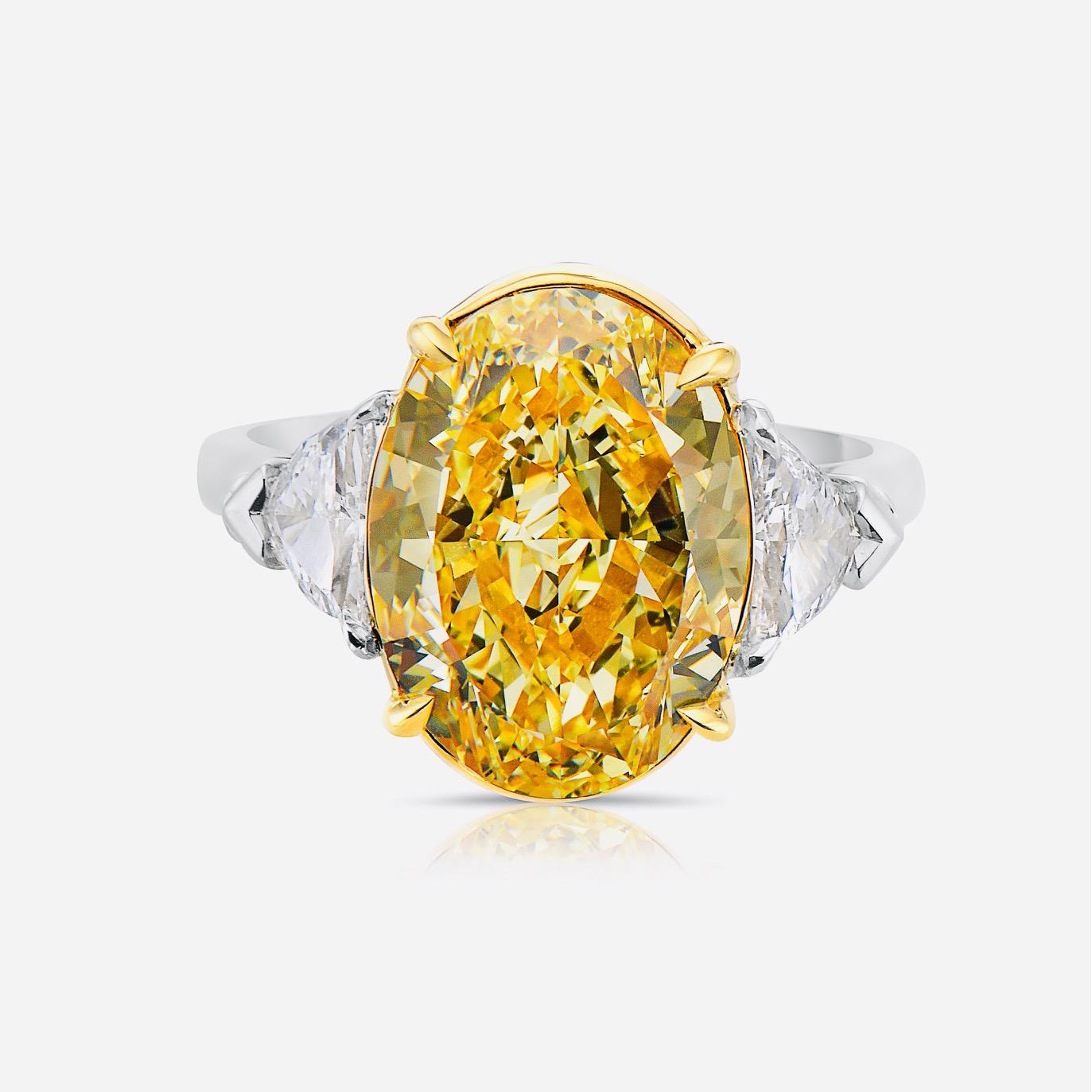 From The Vault at Emilio Jewelry Located on New York's iconic Fifth Avenue,
Showcasing a very special and rare Gia certified natural fancy intense yellow oval diamond set in the center. Spectacular Ring! Total weight listed in title. 
We specialize