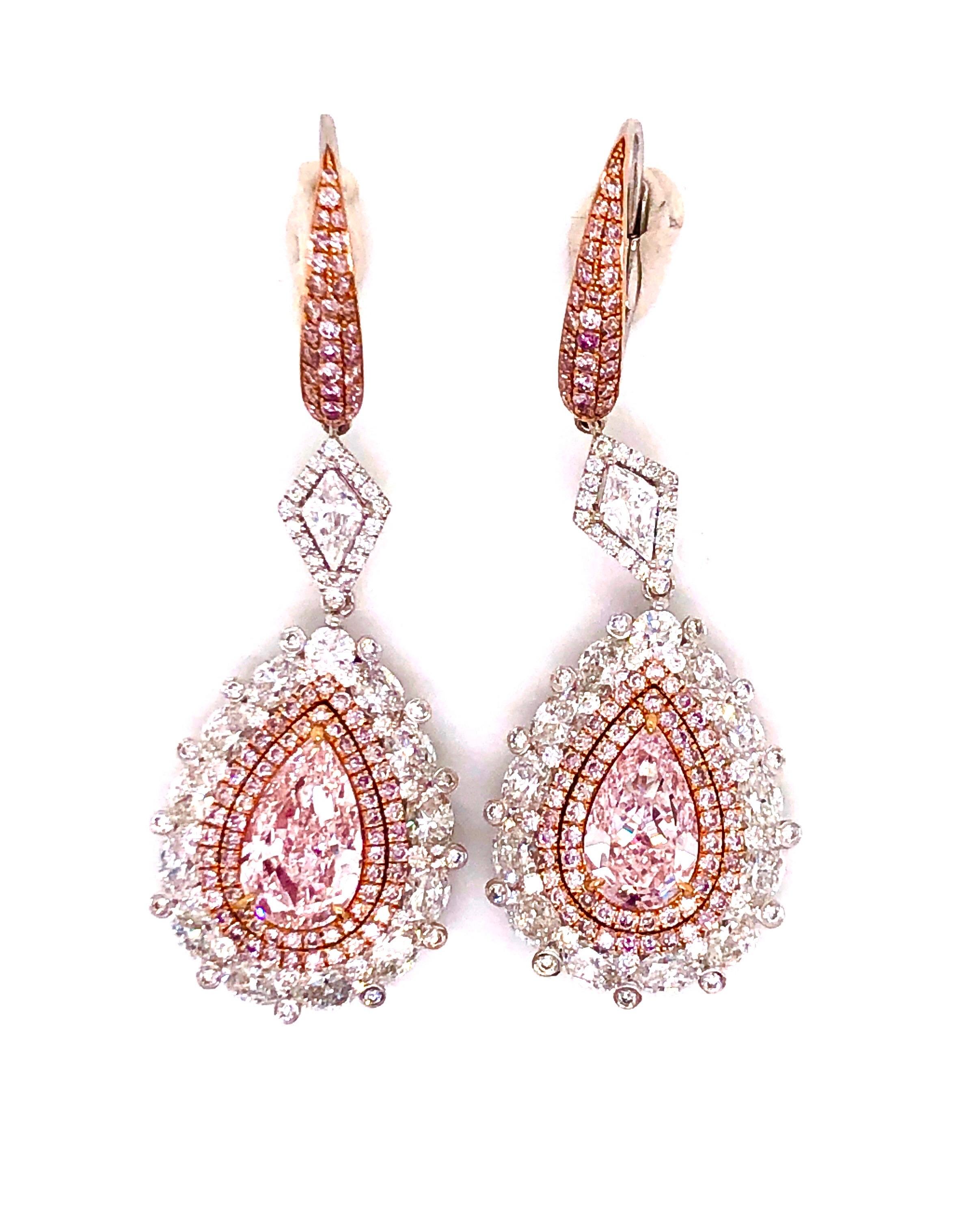 Showcasing 2 spectacular GIA certified natural pink diamonds just under 2.50ct for the pair. The clarity is exceptional indicated as vvs1/vs1. Please inquire for the GIA certificates and the total weight of these earrings (with the pave