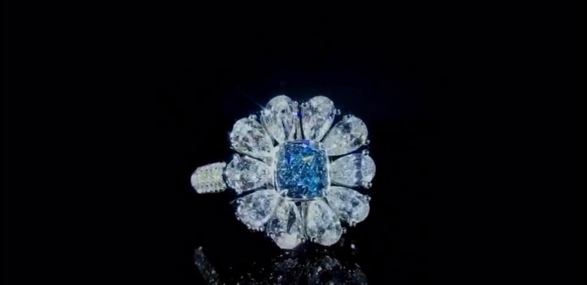 From the Emilio Jewelry Museum Vault, Showcasing a magnificent investment grade .80ct carat Gia certified natural fancy light g. blue center stone. With Emilio's expertise after setting the center faces up with a visual of fancy intense blue!