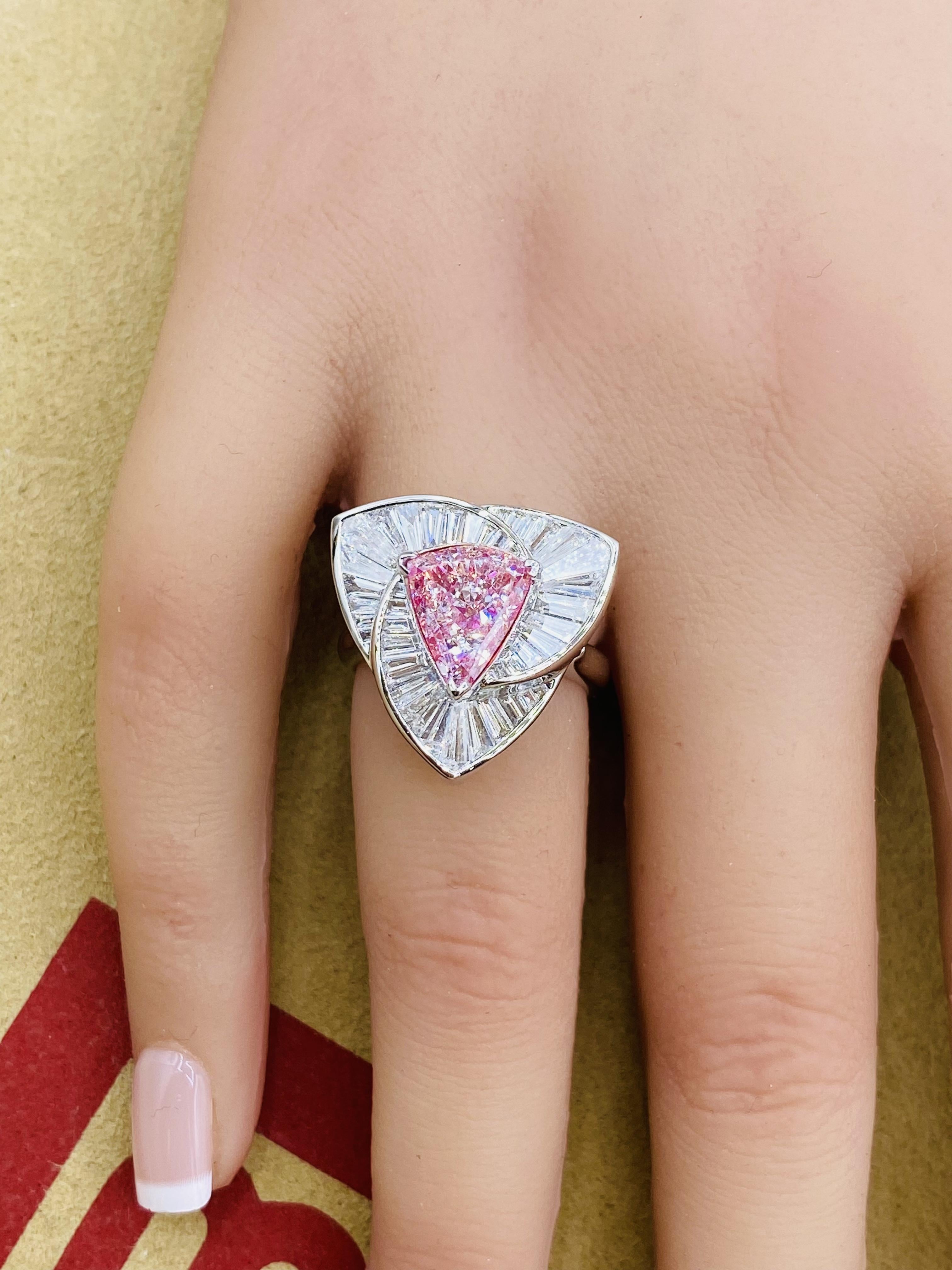 A trilliant cut pink diamond is a stunning gemstone known for its unique triangular shape, which features three beveled edges that enhance its brilliance and sparkle. This cut maximizes light reflection, giving the diamond a vibrant and lively