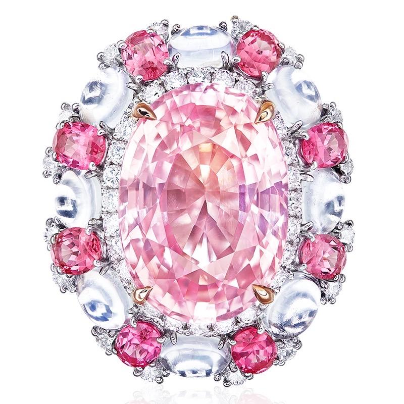 From the museum vault at Emilio Jewelry New York,
Main stone: 14.50 carat Orange-Pink OVAL
Treatement: None, unheated or untreated.
Setting: 78 white diamonds totaling approximately 0.99 carats, 8 moonstones totaling approximately 1.99 carats,