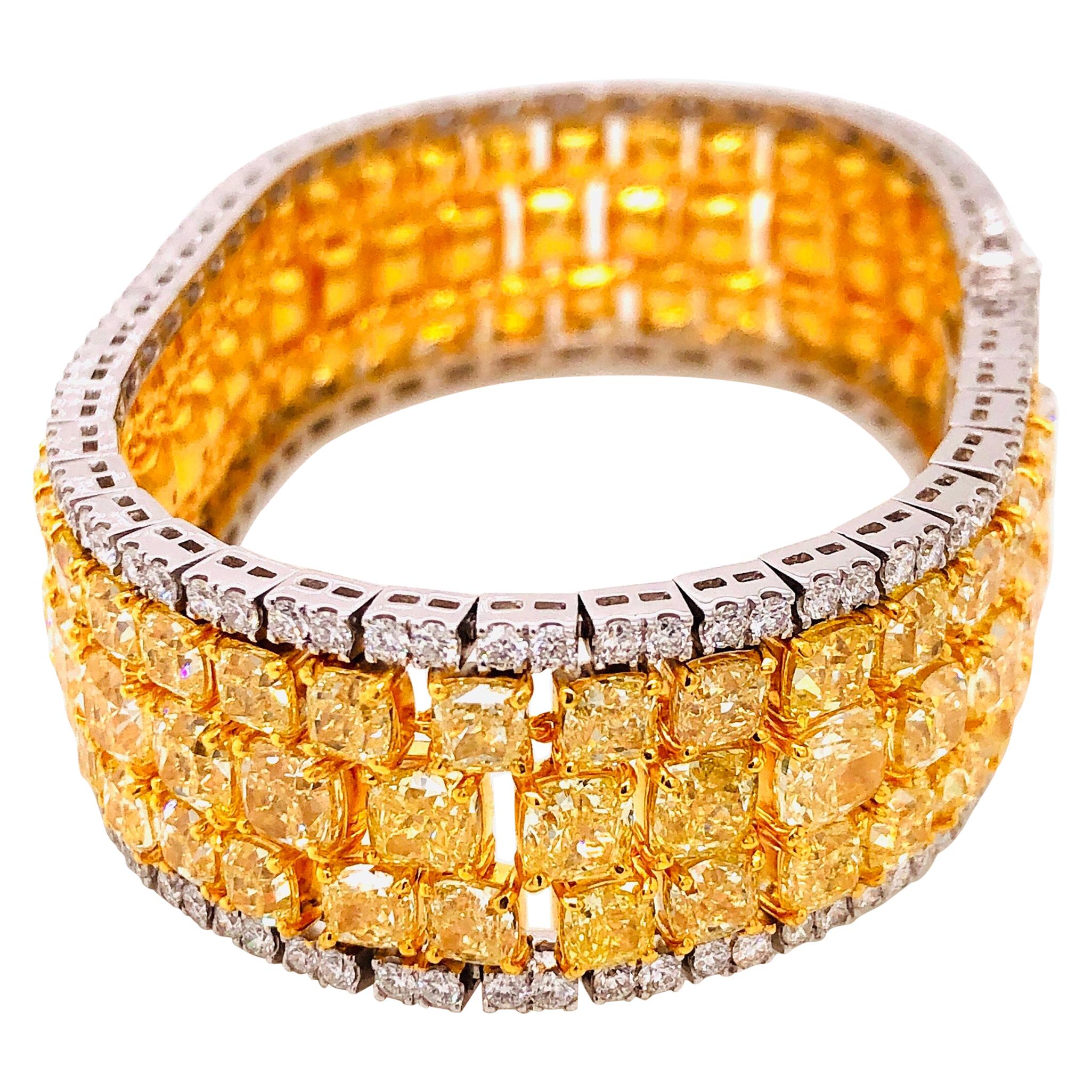 Showcasing a knockout natural yellow diamond bracelet with approximately 46.81ct total weight. Measures 1.80cm wide or 3/4 of an inch and 7 inches long. The color hue and saturation in our opinion face up as fancy intense after setting! Every