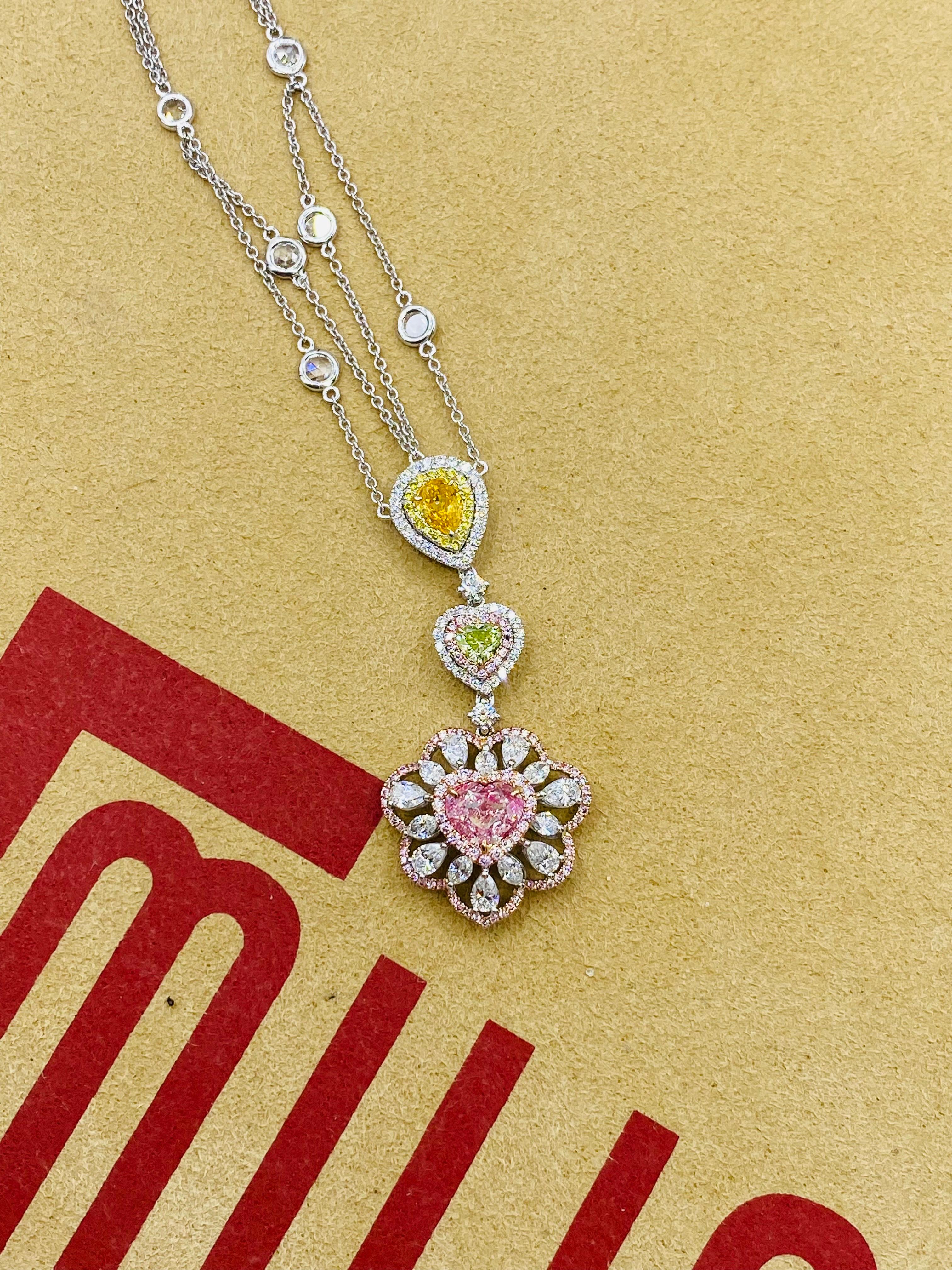 From the vault at Emilio Jewelry located on New York's iconic Fifth Avenue,

Featuring a Gia Certified natural light pure pink diamond heart at the bottom weighing 1.00ct 
and an additional two natural fancy color diamonds weighing .26ct and .18ct.