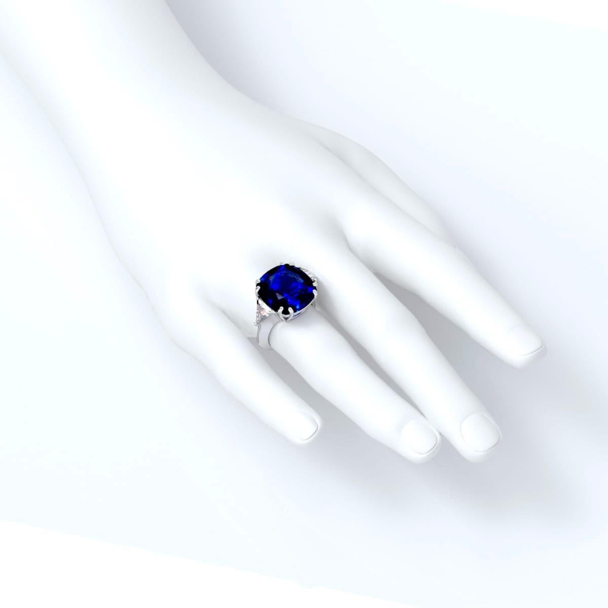 Approx total weight: 16.36ct 
Center Stone: 15.76cts 
Certified by C. Dunaigre as a Vivid blue Ceylon Sri Lanka Sapphire 
Diamond Color: D-E
Diamond Clarity: Vvs1
Cut: Excellent
Sapphire quality: Gorgeous deep blue color. The center stone is full of