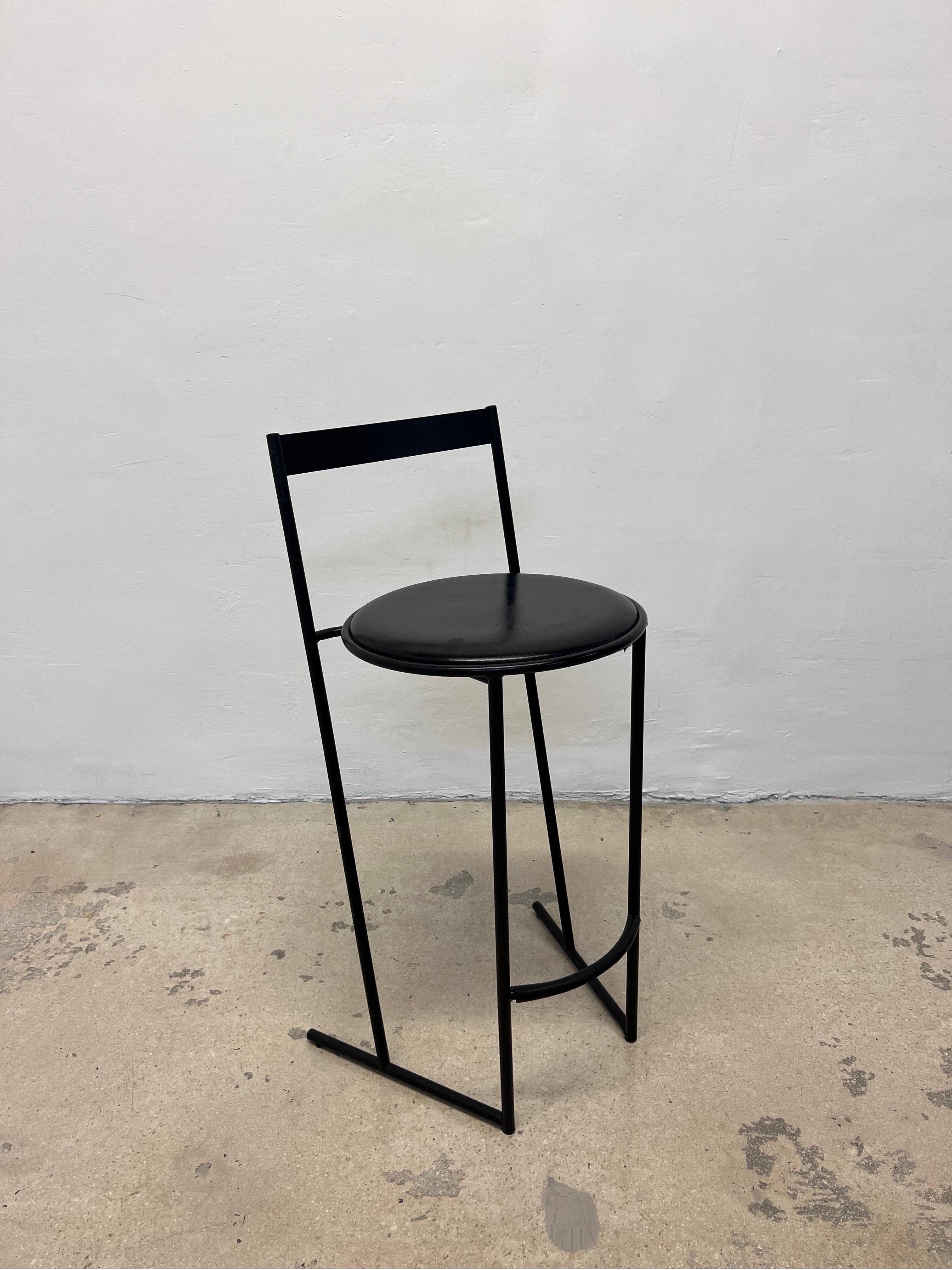 Considered one of his first chair designs, the Musmé counter stool was designed by Emilio Nanni for Fly Line. The stool consists of a steel cantilevered frame and a black vinyl seat.