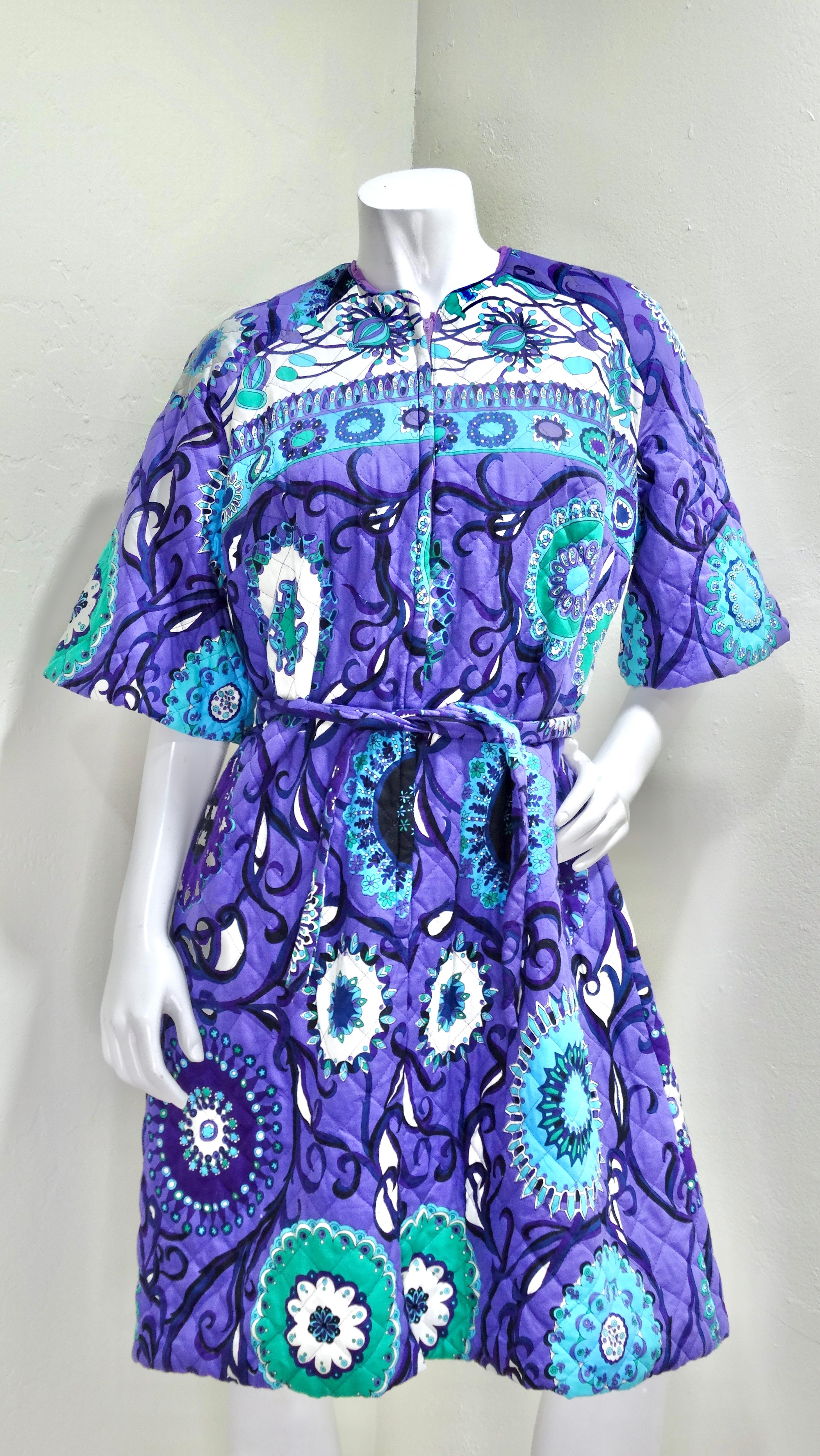 Don't miss out on the chance to snag a rare piece of 1960's Pucci that features a fully cotton diamond-quilted fabric. Details include a zipper on the front, a tie waist, bell sleeves, and hues of green, blue, and purple. Pair this dress this some