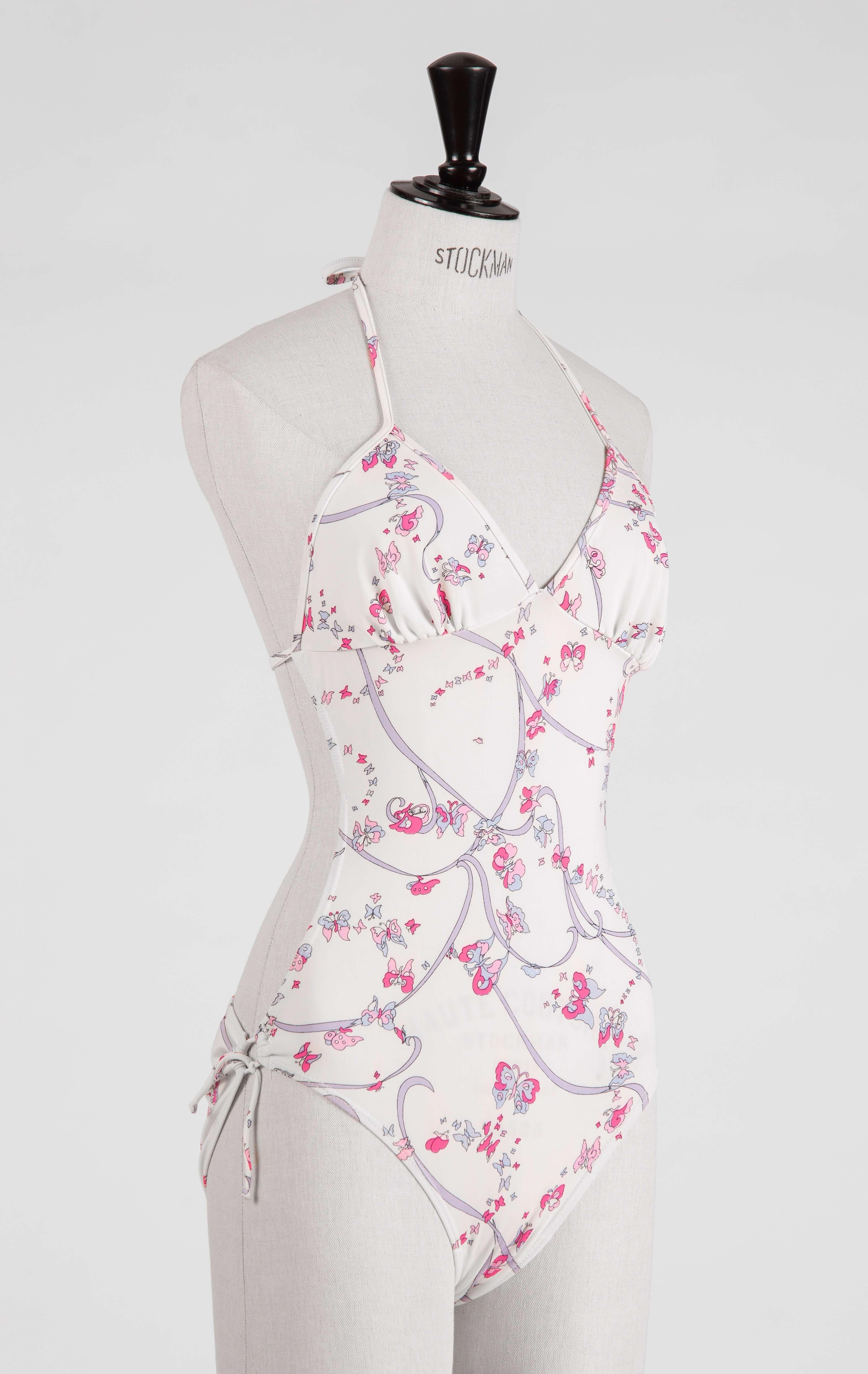 Add a dose of Emilio Pucci's 1970s signature jet set glamour to your beachwear or vintage fashion collection. This fabulous and rare one-piece vintage swimsuit is splashed with one of Pucci's iconic butterfly prints in neon pink, baby pink, blue and