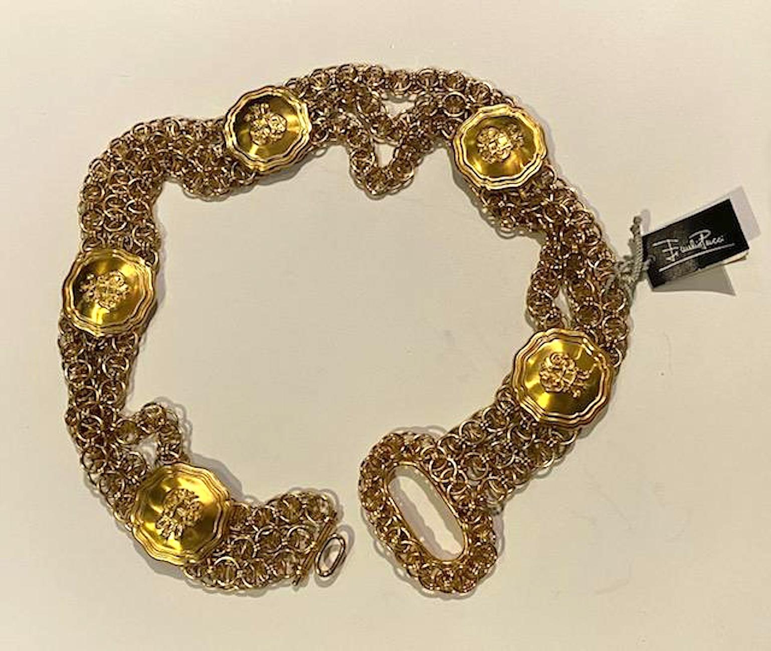 A 1980s triple strand wide chain belt with five medallions by iconic fashion house Emilio Pucci. Each of the three strands and the buckle are double thick links in shiny gold tone. The five medallions are satin gold tone for contrast and measure