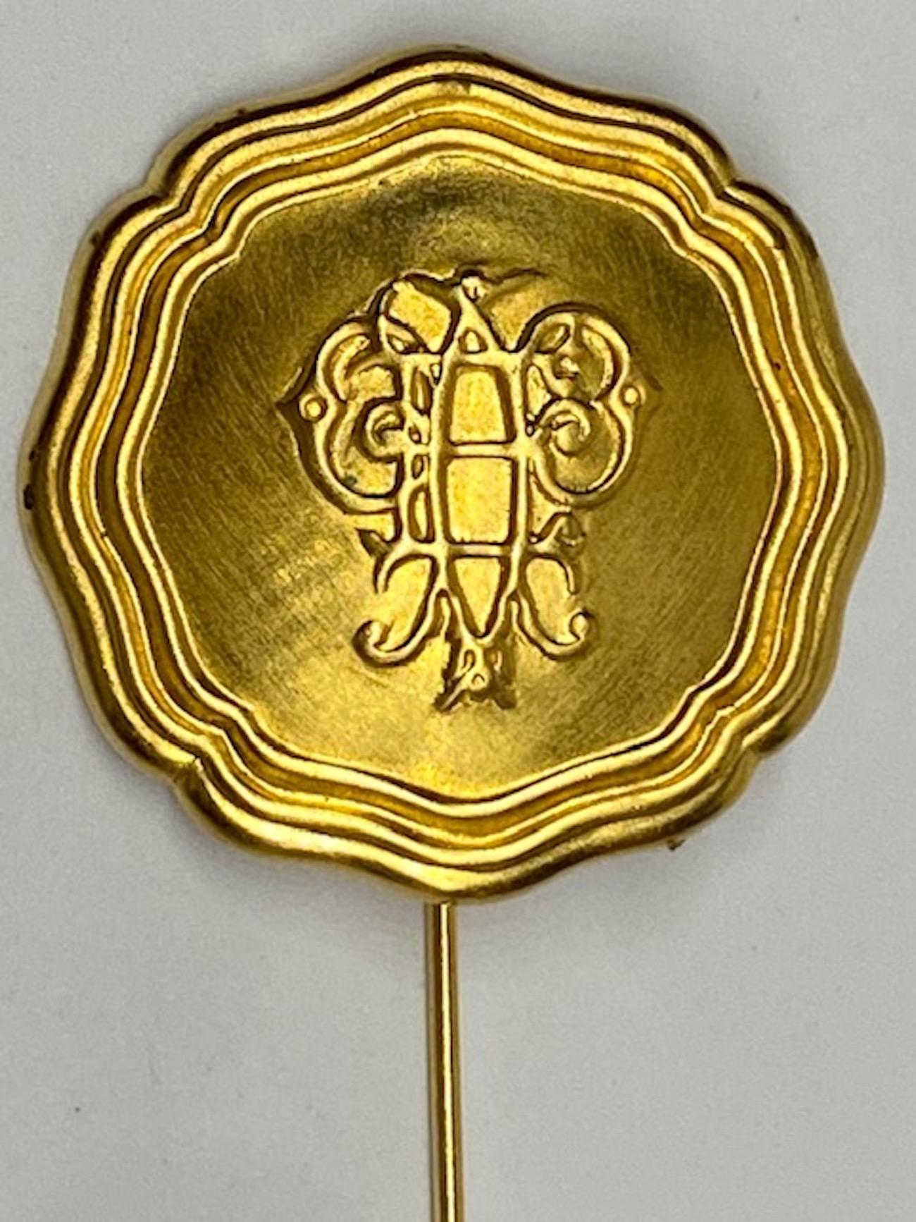 Part of a collection of Emilio Pucci monogramed medallion jewelry from the 1980s. The medallion is satin gold tone and has a scrip monogram of the letter E and P for Emilio Pucci. The medallion is 1.38 inches in diameter. The pin without the