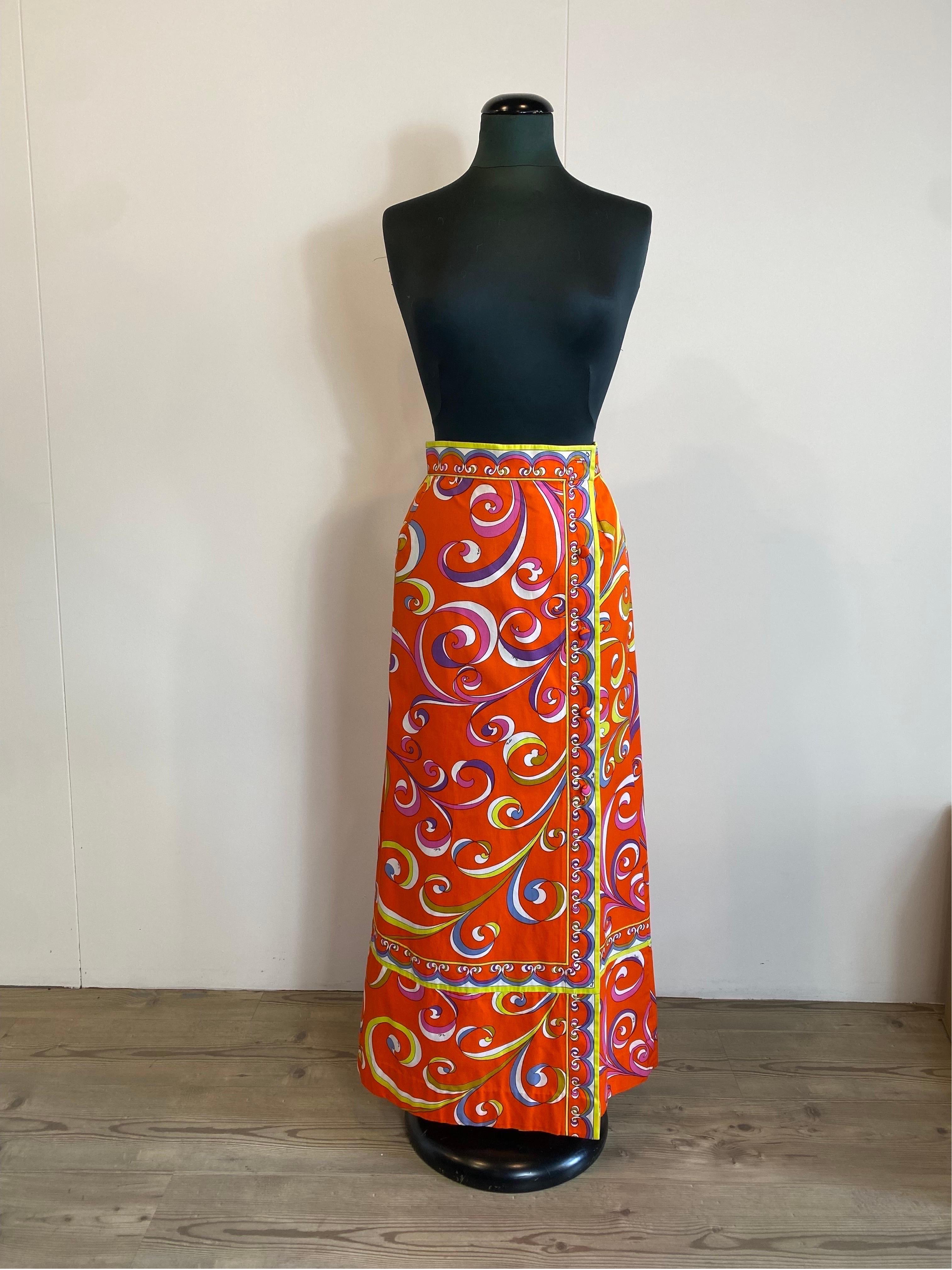 Emilio Pucci long Skirt. 
70s vintage piece.
Composition label missing but we think it is cotton.
Iconic Pucci pattern in shades of orange.
The first button is missing but the skirt closes anyway thanks to the internal hooks.
Size 10 which