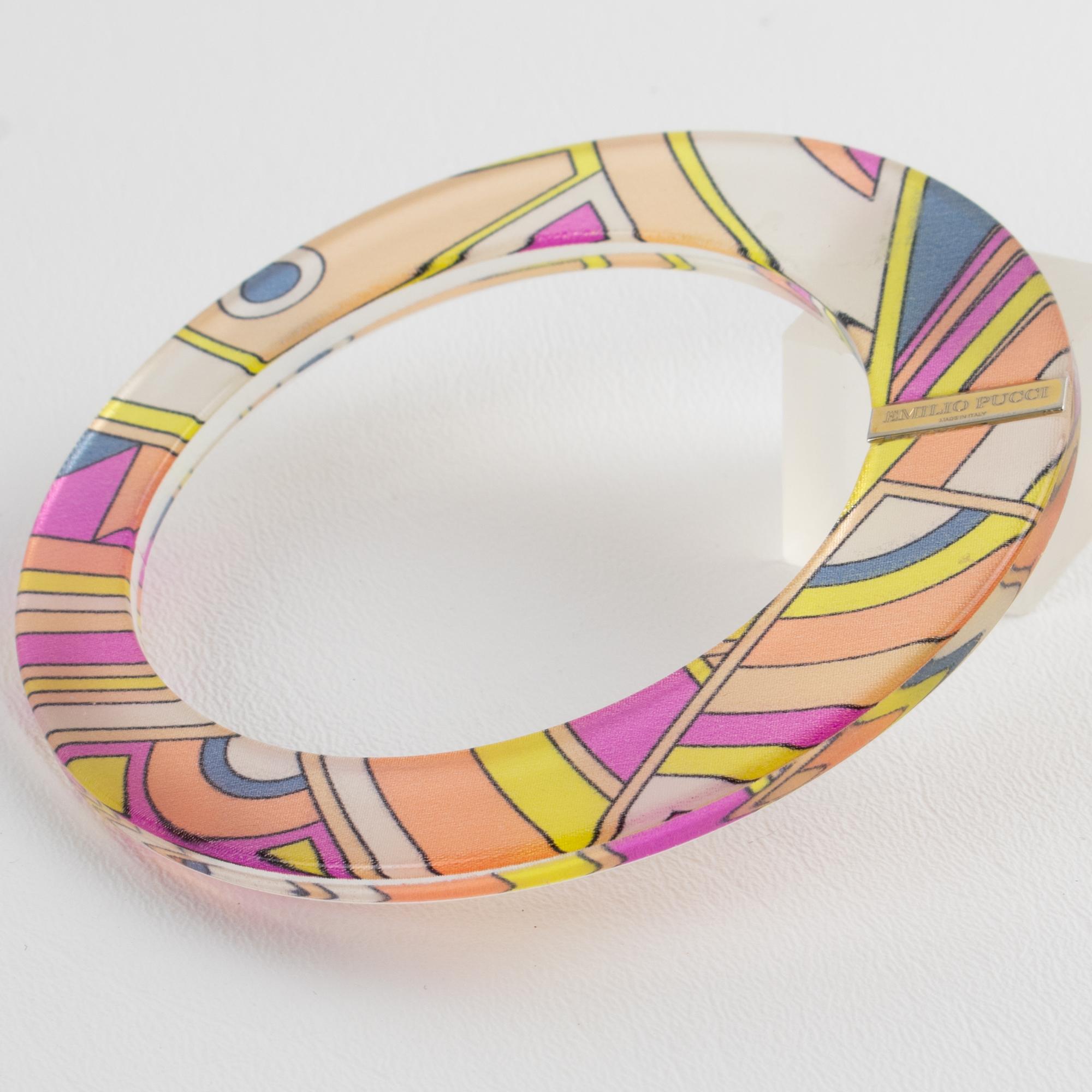 This stunning Emilio Pucci acrylic or Lucite bracelet boasts an asymmetric bangle shape featuring an extra-wide flat band with multicolored Pucci silk inclusions. The rare bracelet is embellished with an asymmetric flat construction contrasted with