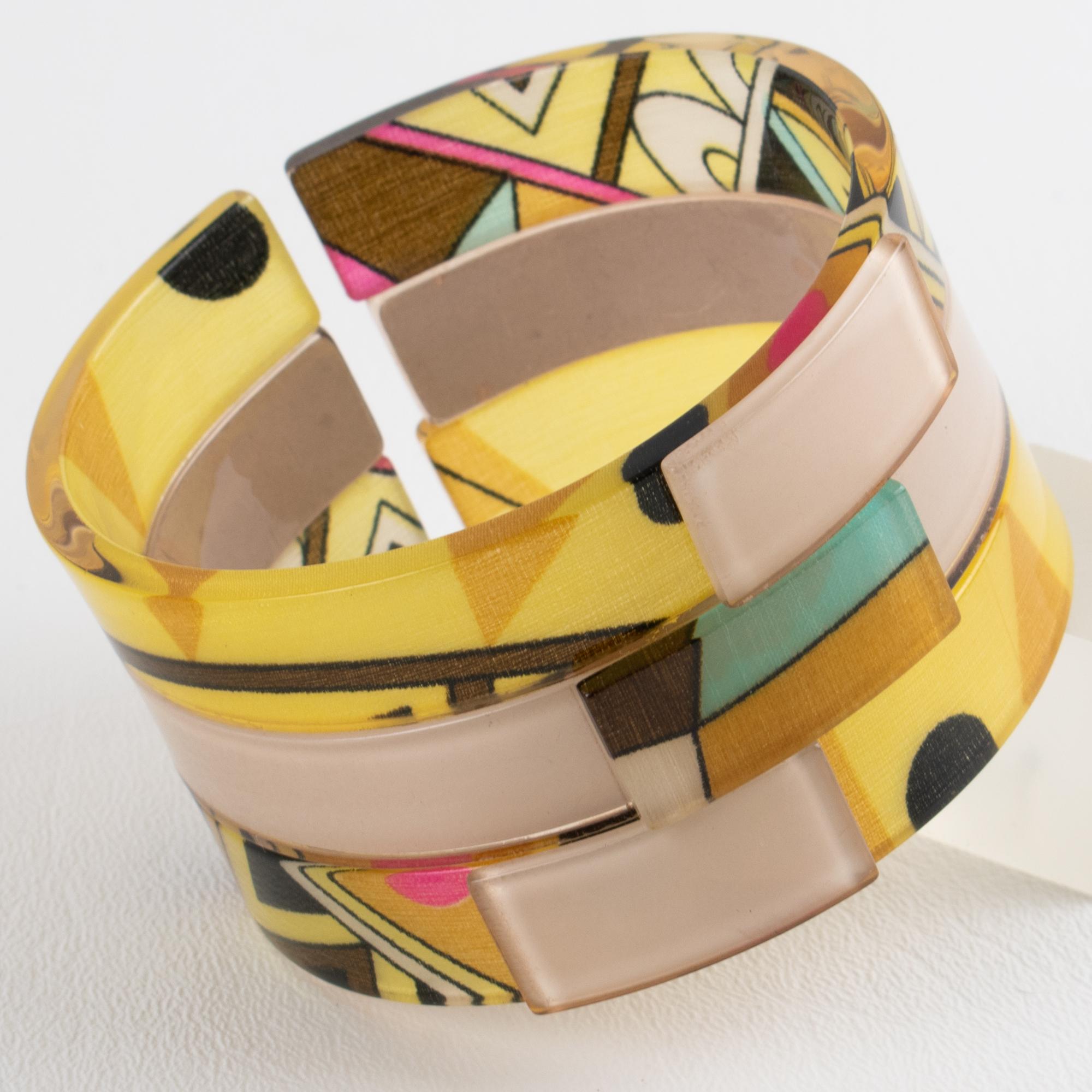 This stunning, chunky Emilio Pucci acrylic or Lucite bracelet boasts a large open bangle shape featuring a multi-layer acrylic band with multicolored Pucci silk inclusions. The rare bracelet is embellished with a geometric construction on the front