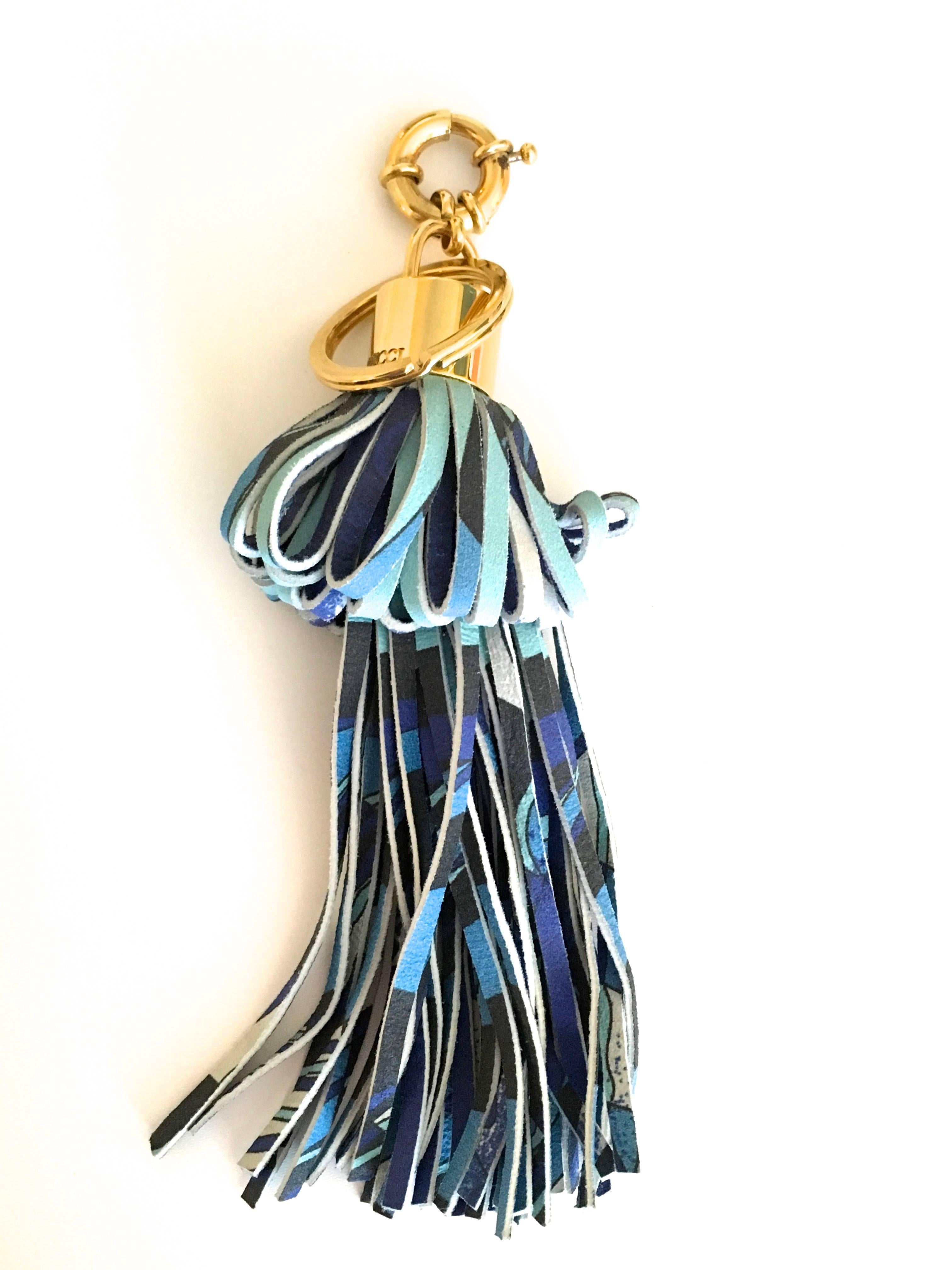 Presented here is a bag charm from the Emilio Pucci fashion house. This gorgeous charm is crafted from strips of leather from a design that is definitively Pucci. The strips of leather have been woven together into a accessory that can either be