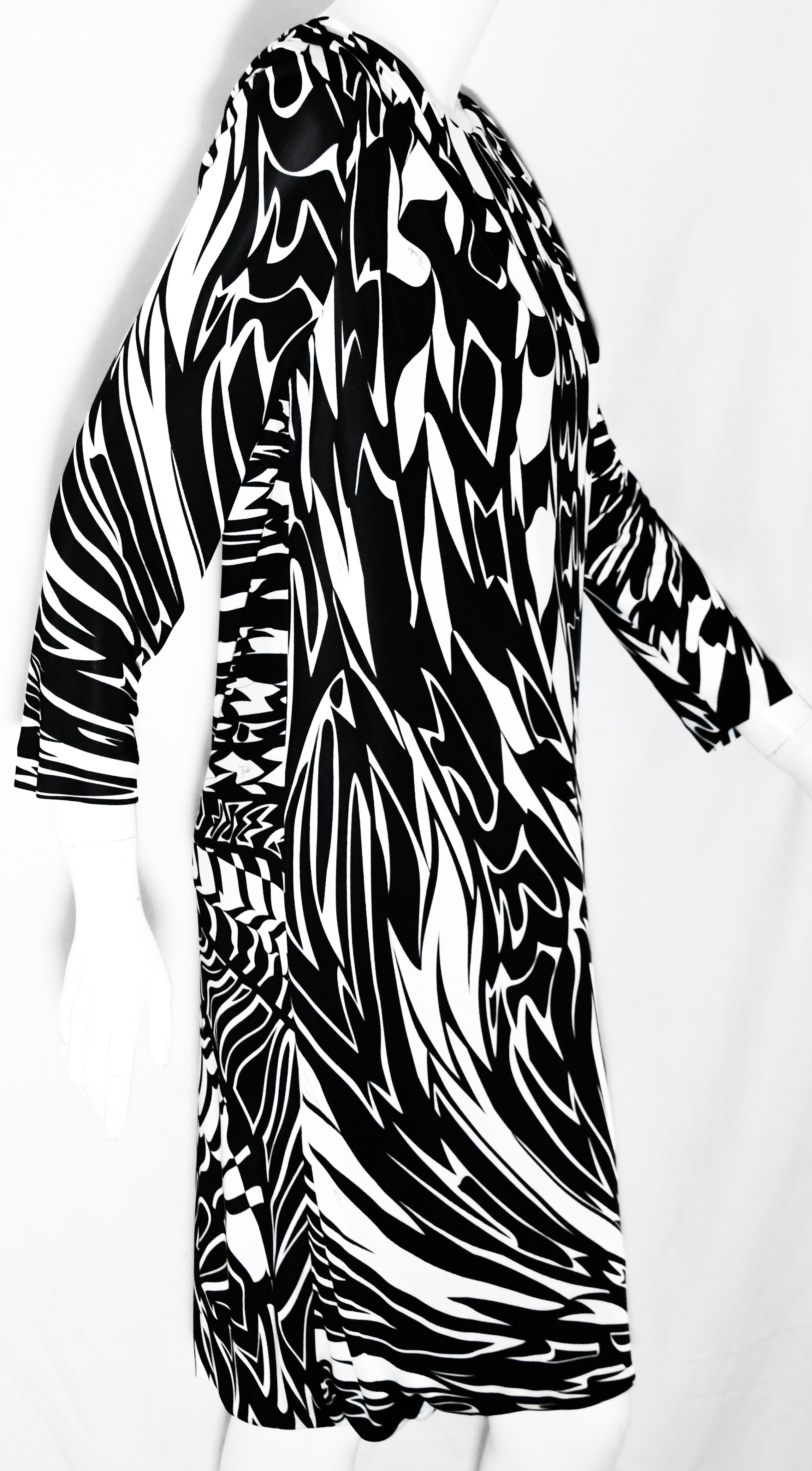 Emilio Pucci black and white abstract design dress with 3/4 length sleeves is accentuated with mini pleats on shoulders.  The total look at Emilio Pucci is  inspired by Victor Vasarely’s kinetic art designs at the 2016 Collection.  This shift dress