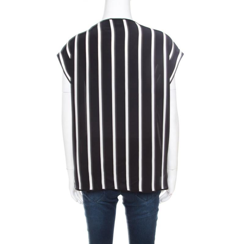 Cut from 100% silk, this Emilio Pucci sleeveless top is perfect for a casual outing with friends. Styled in an oversized silhouette, this top comes with a black and white striped pattern all over. Style yours with denim jeans and nude