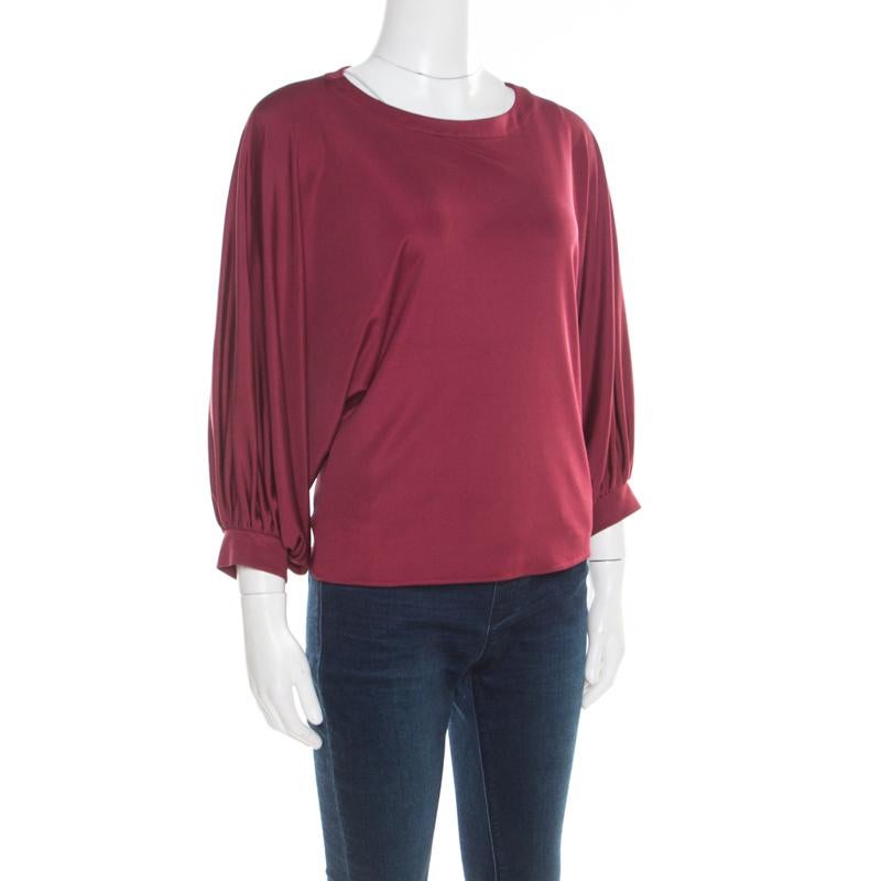 This Emilio Pucci top can be paired with almost everything in your wardrobe. This burgundy piece would make you the centre of attention of any event in seconds. Tailored from silk, this top would keep you at the top of the style game.

Includes: The
