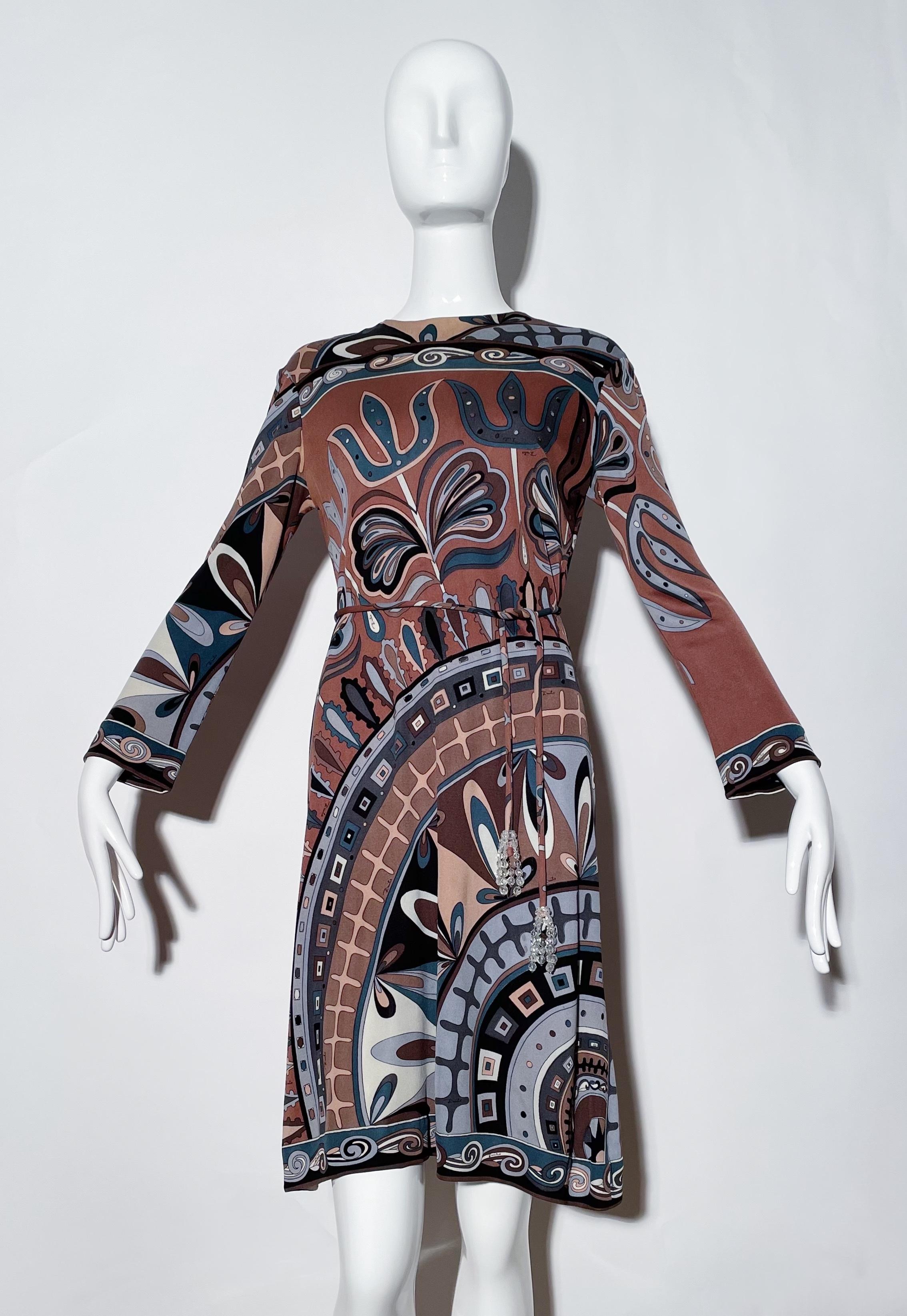 Brown Pucci patterned dress. Longsleeve. Removable belt. Rear zipper closure. Silk. Made in Italy. 
*Condition: excellent vintage condition. No visible flaws.

Measurements Taken Laying Flat (inches)—
Shoulder to Shoulder: 17 in.
Bust: 34 in.
Waist: