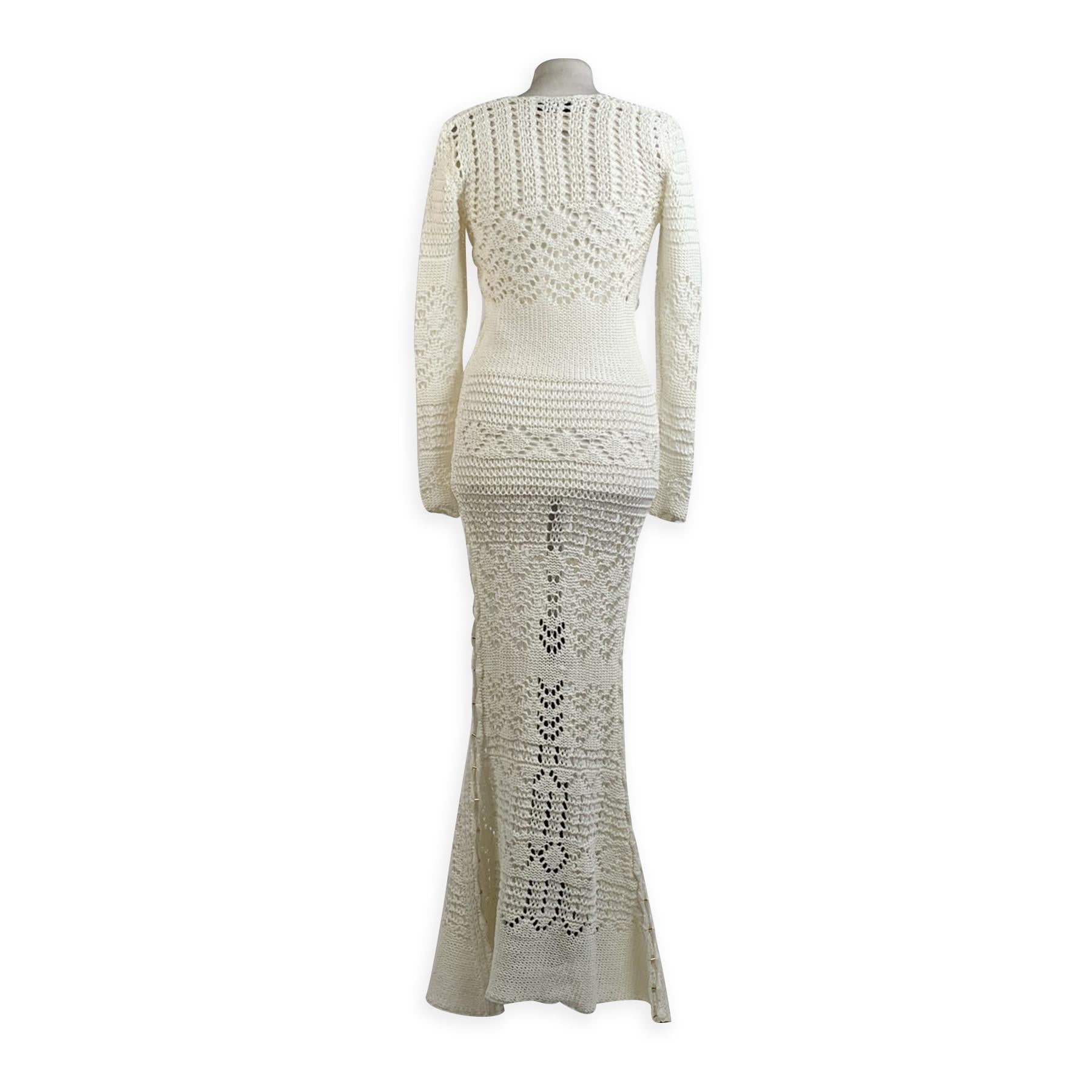 Stunning Emilio Pucci maxi crochet dress in white color, designed in 2011 by Peter Dundas. It features long sleeve styling and a key-hole detail with beautiful gold-tone clasp on the front. Cut-out detailing on the sides with gold tone accents.