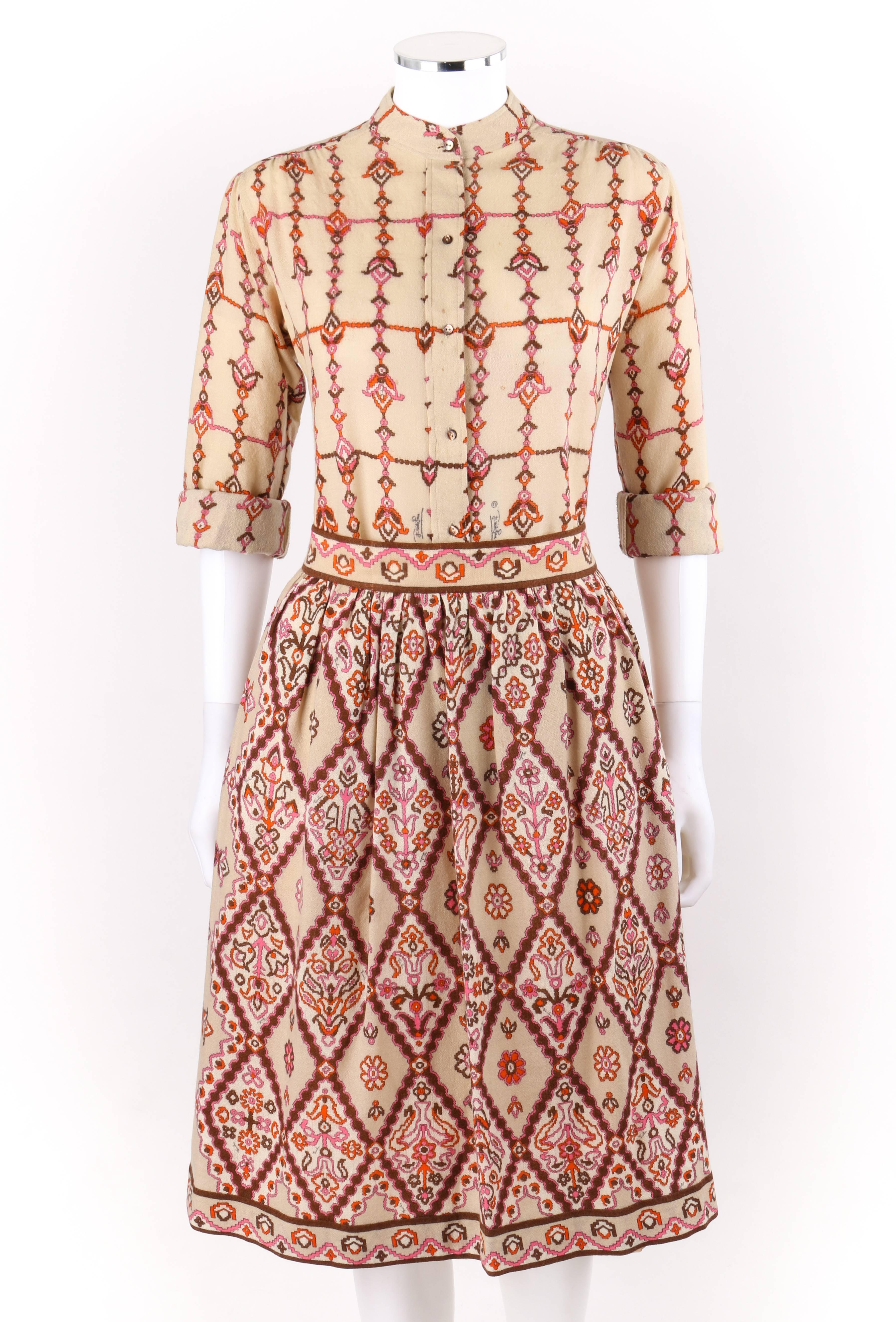 Vintage Emilio Pucci c.1950's two-piece beige floral signature print shirt gathered skirt set. Multi-color tribal floral signature print in shades of orange, pink, and brown on beige wool. Mandarin collar shirt. Six center front black mother of