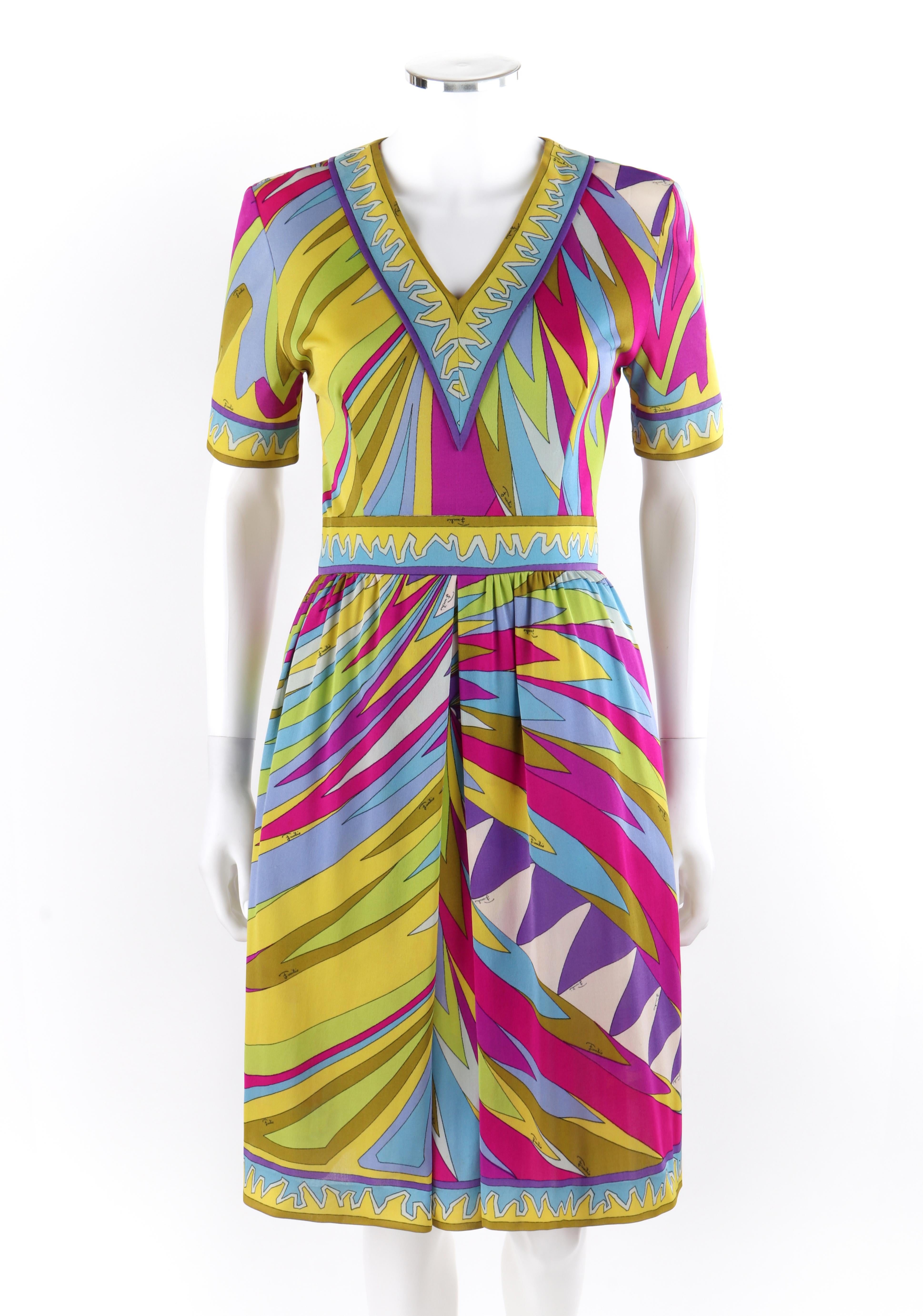 EMILIO PUCCI c.1960's Abstract Stripe Op Art Signature Print V-Neck Sheath Dress
 
Circa: 1960’s
Label(s): Neiman Marcus Trophy Room
Designer: Emilio Pucci
Style: Sheath dress
Color(s): Shades of pink, purple, green, blue, yellow, white
Lined: