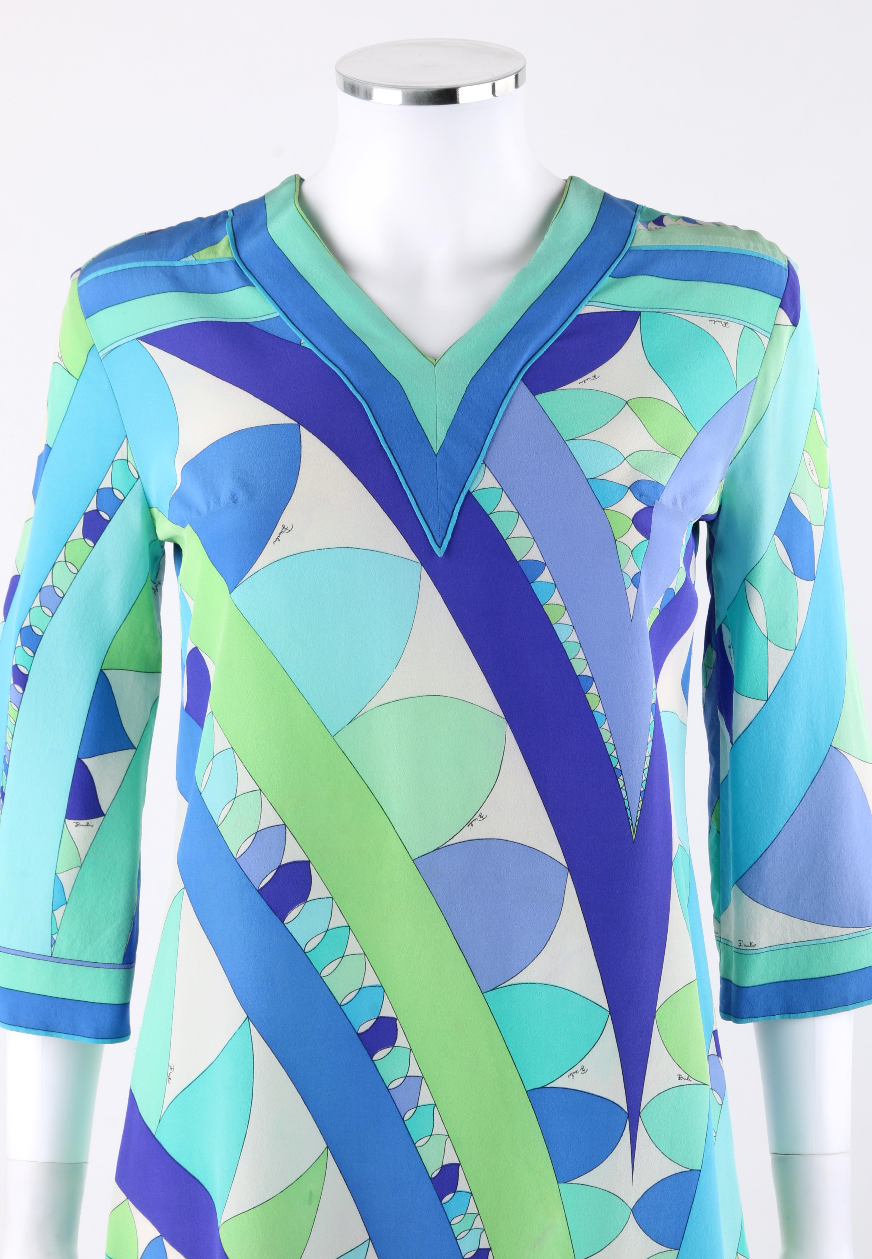 EMILIO PUCCI c.1960’s Blue Green Geometric Signature Print Shift Dress
 
Circa: 1960’s 
Label(s): Emilio Pucci   
Style: Shift Dress
Color(s): Shades of blue, green, white, black. 
Lined: No
Marked Fabric Content: 100% Silk 
Additional Details /