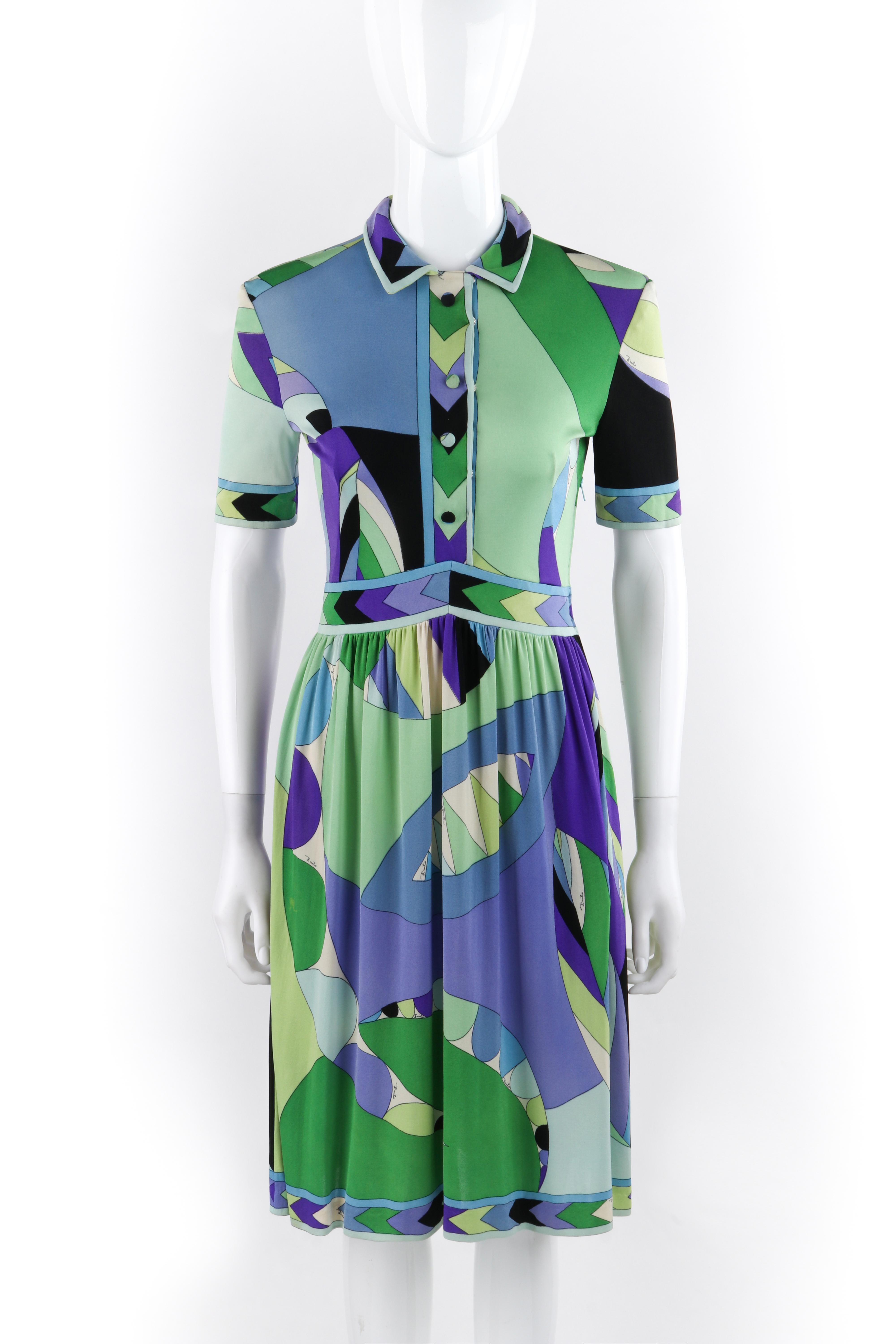 EMILIO PUCCI c.1960’s Button Front Signature Geometric SS Silk Day Dress
Circa: 1960’s
Label(s): Emilio Pucci; Made in Italy for Lord & Taylor
Designer: Emilio Pucci
Style: Day dress
Color(s): Shades of green, blue, purple, white, and black
Lined: