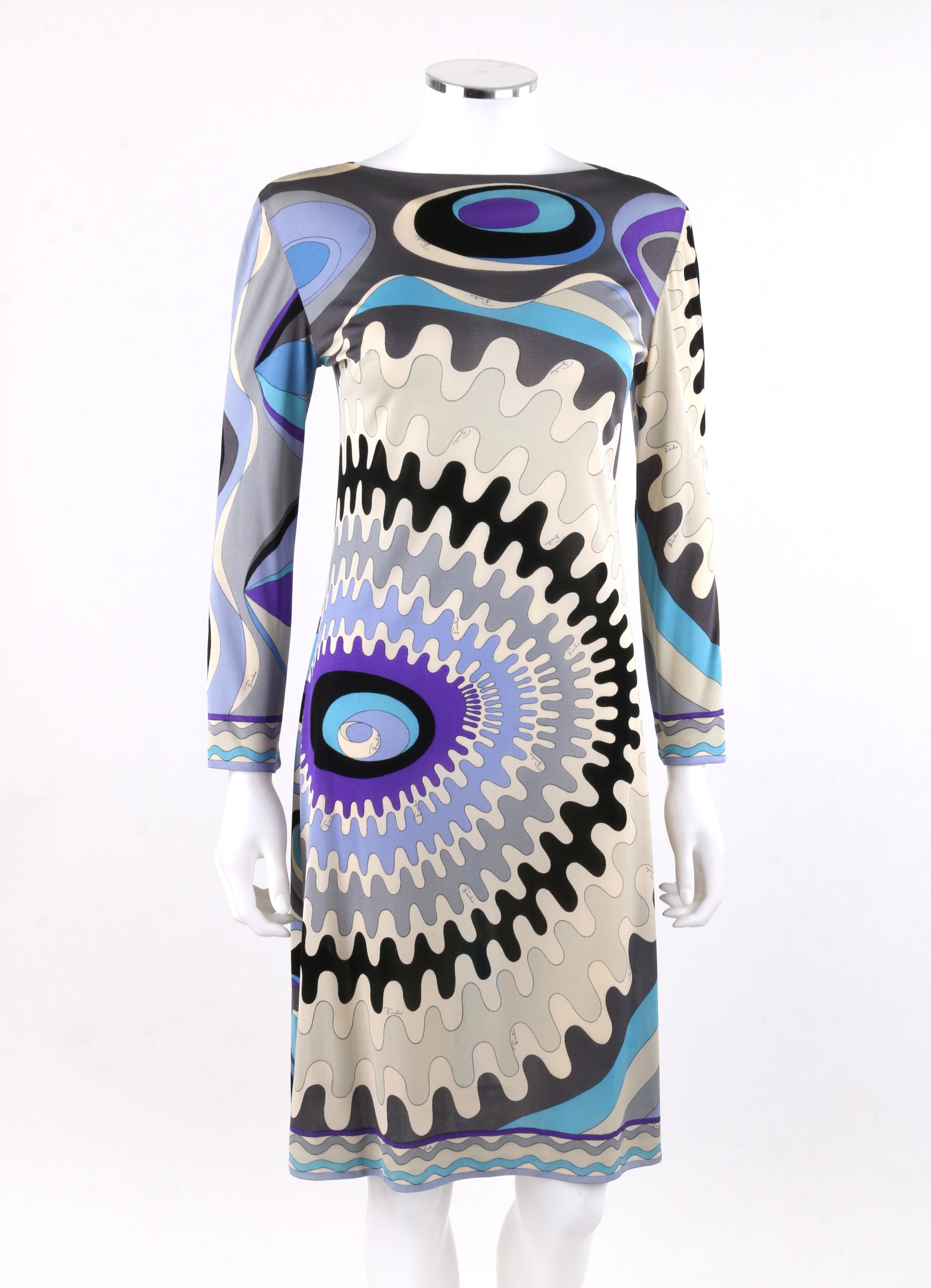 EMILIO PUCCI c.1960’s Blue Mod Op Art Signature Print Silk Jersey Knit Wedge Dress
 
Circa: 1960’s
Label(s): Emilio Pucci / Exclusively for Lord & Taylor 
Style: Wedge Dress
Color(s): Shades of blue, grey, purple, black and off-white. 
Lined: