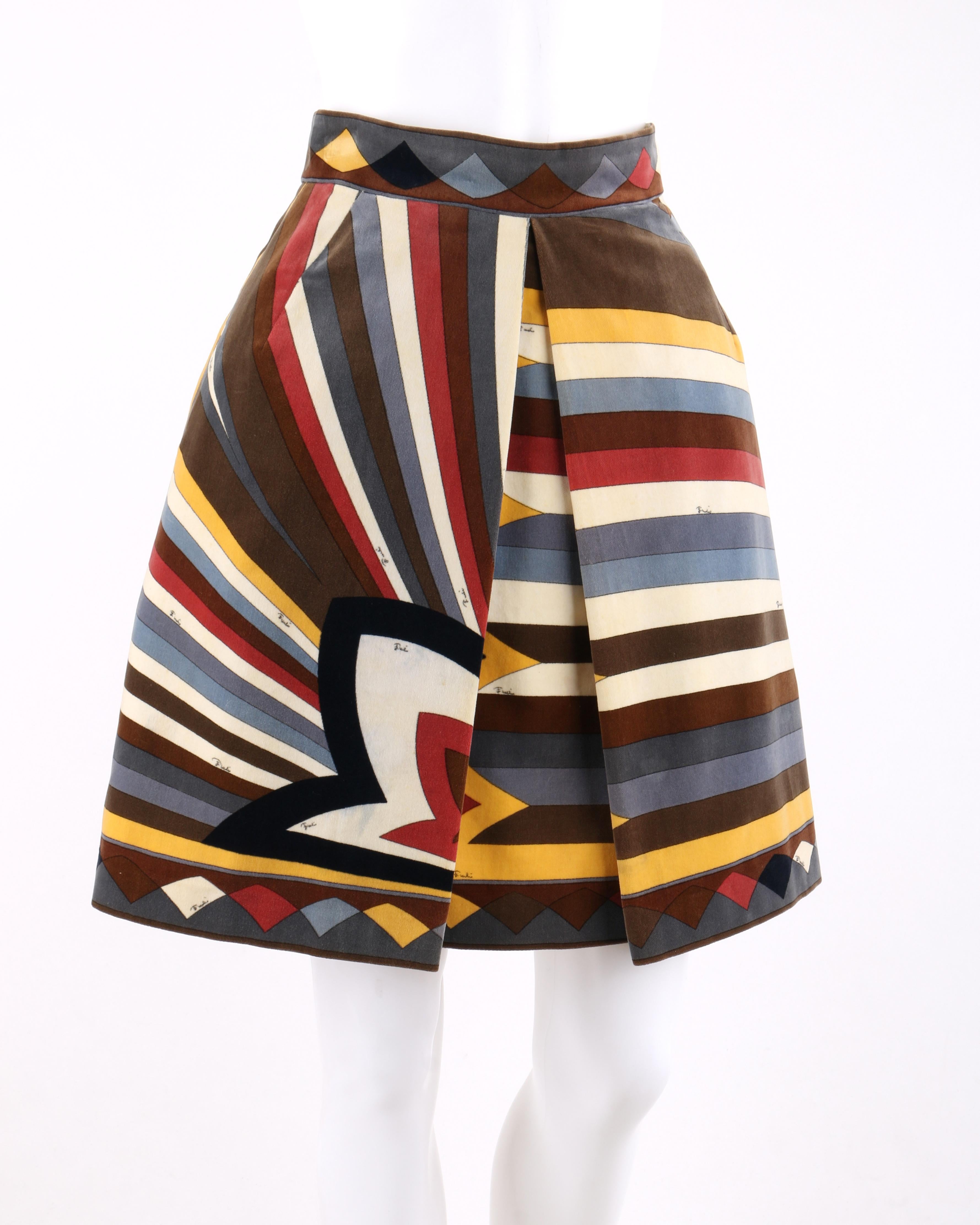 EMILIO PUCCI c.1960’s Multi-color Velvet Signature Print A-Line Pleated Skirt
 
Circa: 1960’s 
Label(s): Emilio Pucci / Exclusively for Sak’s Fifth Avenue.   
Style: A-line skirt
Color(s): Shades of brown, cream, yellow, red, blue, grey and black.